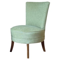 1950s slipper chair in cardamon green chennile with tapered wooden legs