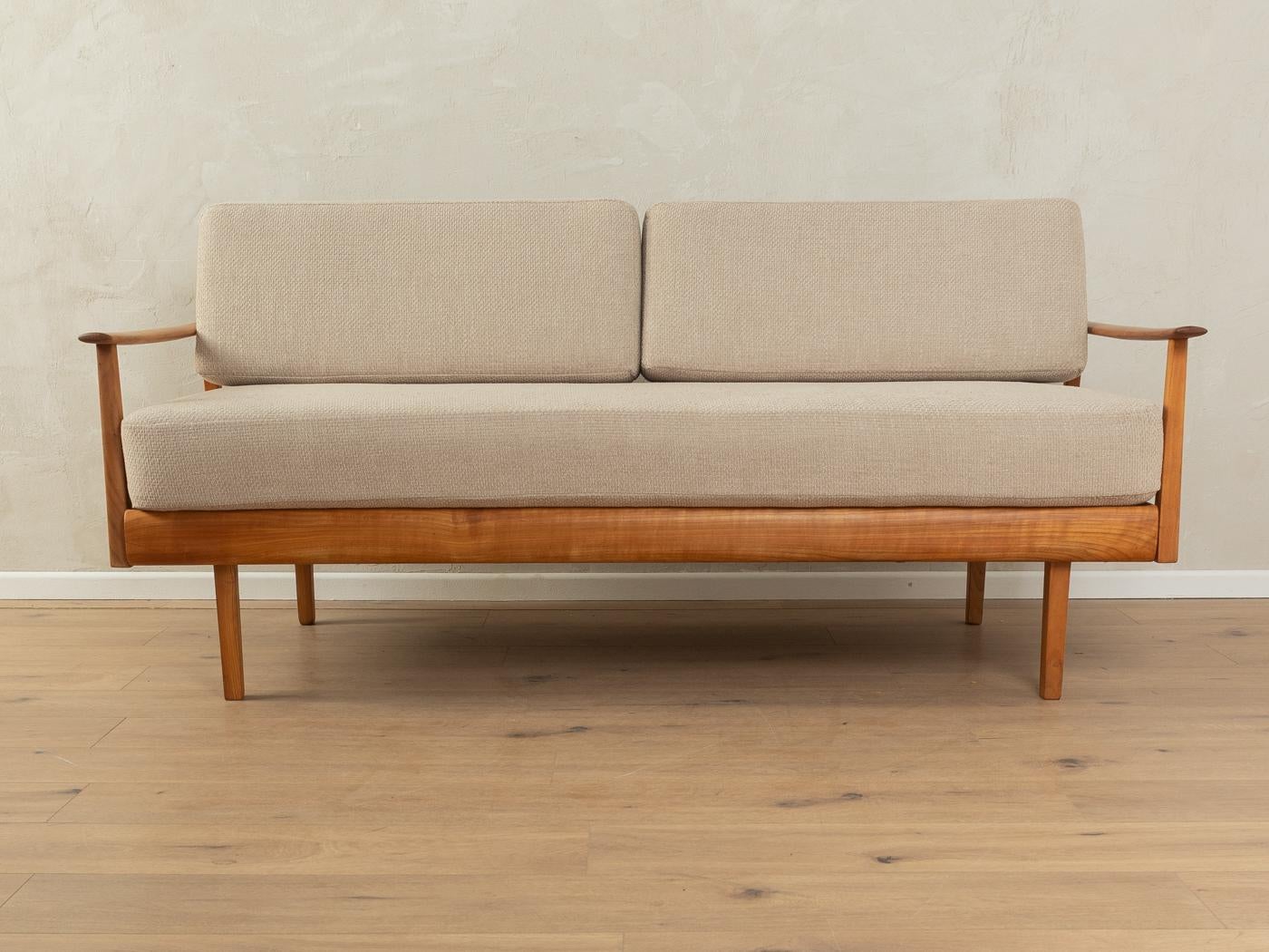 Wonderful sofa from the 1950s. Solid teak stained cherry wood frame with extendable head rest and adjustable back rest. The original spring core has been reupholstered and covered with a high-quality fabric in beige.

Quality Features:

    very