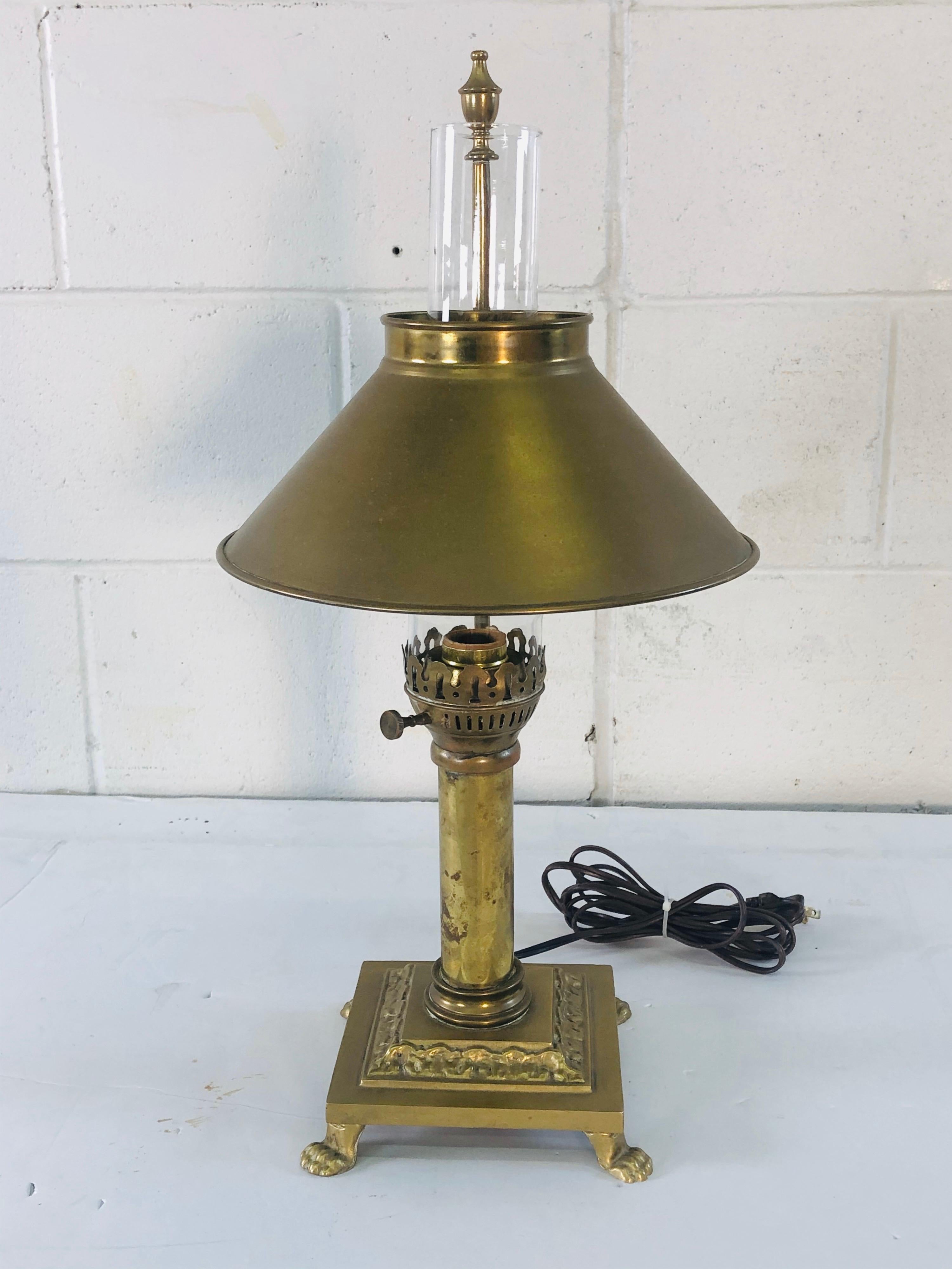 Vintage 1950s solid brass desk lamp with an adjustable shade. The base sits on claw feet. In working condition, no marks. Light tarnish from age. Great design and function.