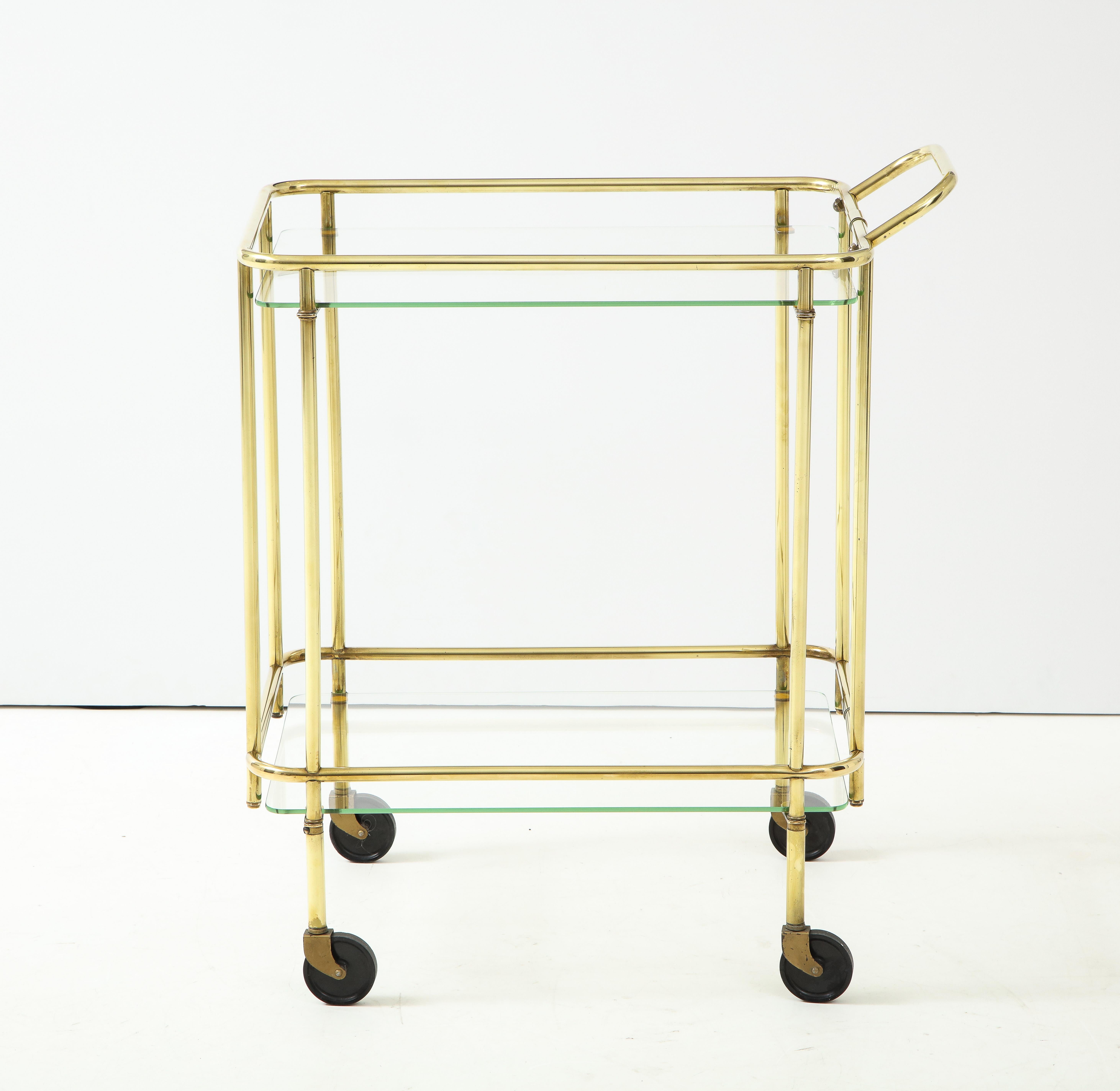 Stunning 1950's Mid-Century Modern solid brass two tier Italian bar cart, in vintage condition with some wear and patina to the brass and light scratches to the glass, lightly hand polished.