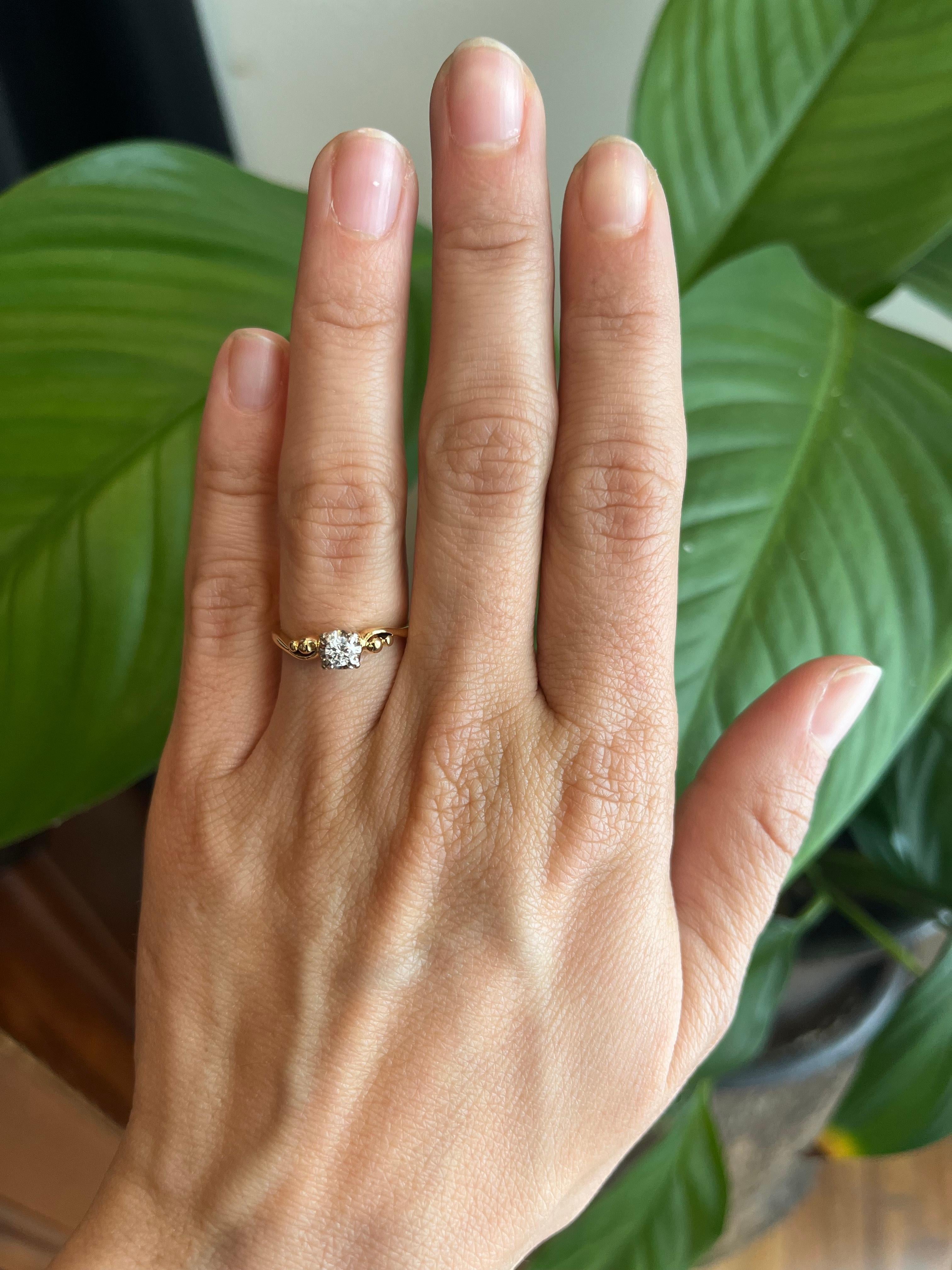 Circa 1950s, this delicate solitaire holds a 0.15ct round diamond in a white gold head with yellow gold band. A classic midcentury silhouette. From our vintage estate jewelry collection.

- Circa 1950s
- 0.15ct round natural diamond, I2 clarity, H-I