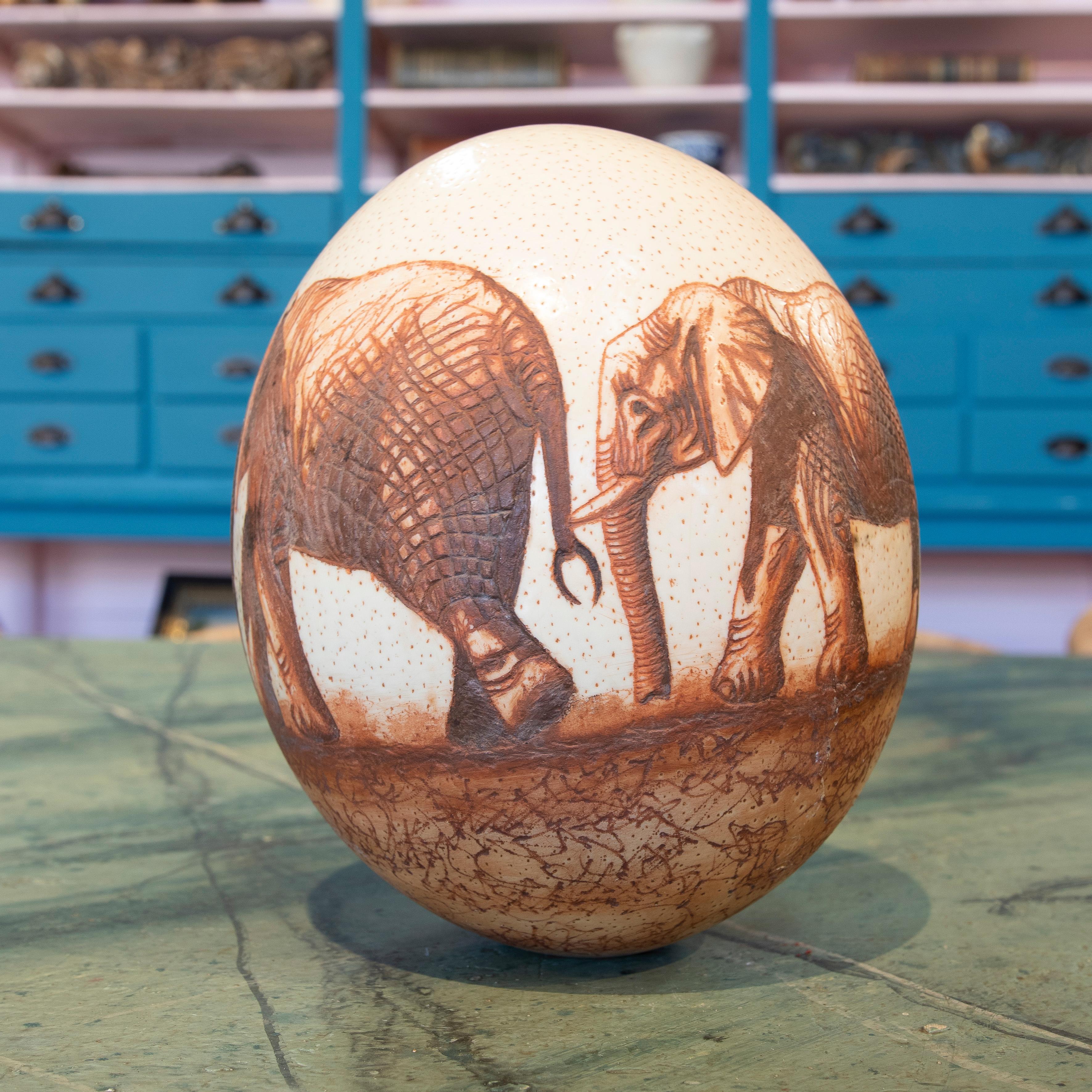 Original 1950s South African scrimshaw ostrich egg by late chief Sipho Ndlvu depicting a pair of elephants.