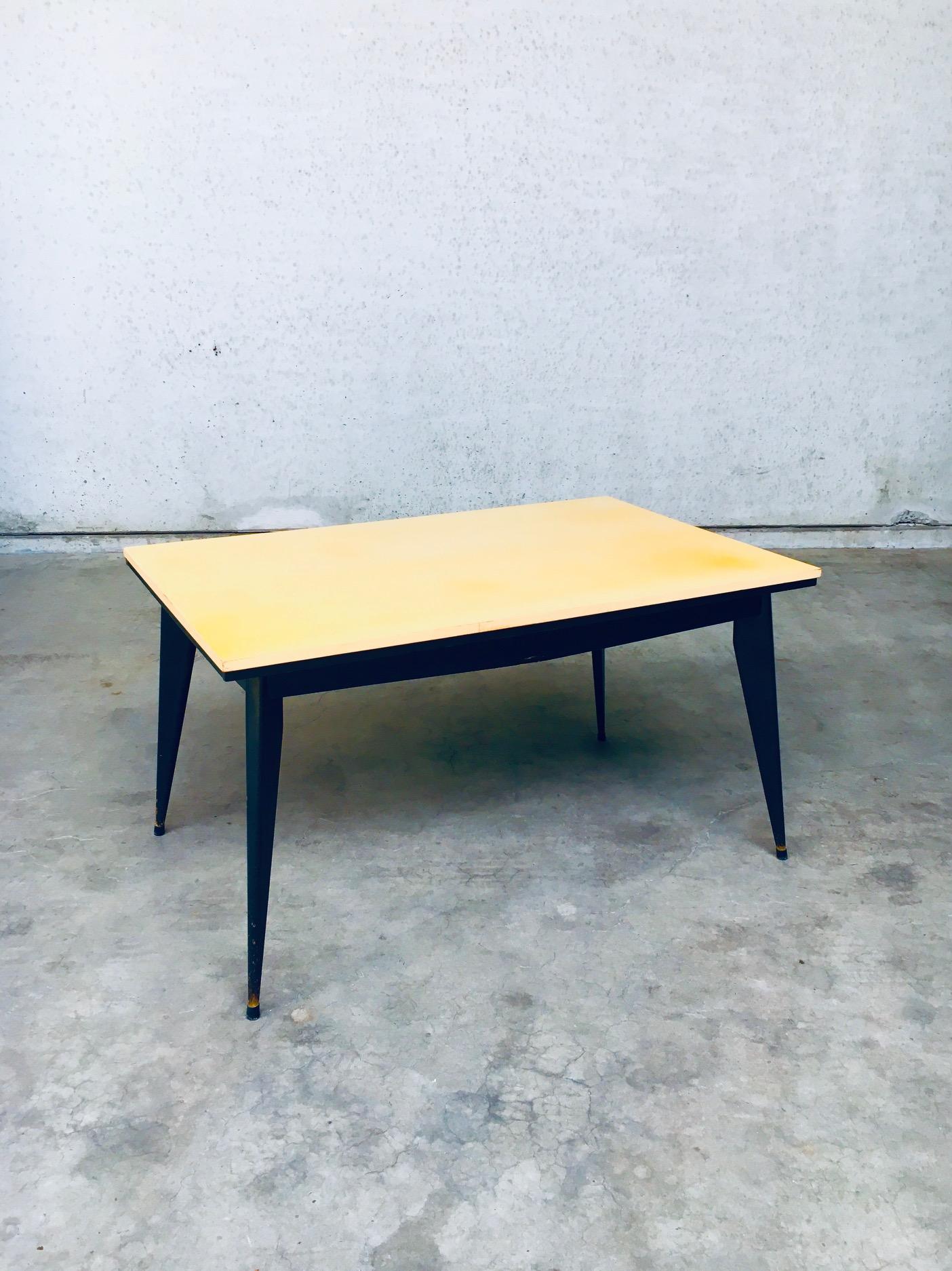Vintage Midcentury Modern Space Age Design Extendable Dining or Kitchen Table. Made in France, 1950's period. This is in the style of Jean Prouvé designer. Entirely constructed in wood. Black base with yellow lacquered top. The extensions are also