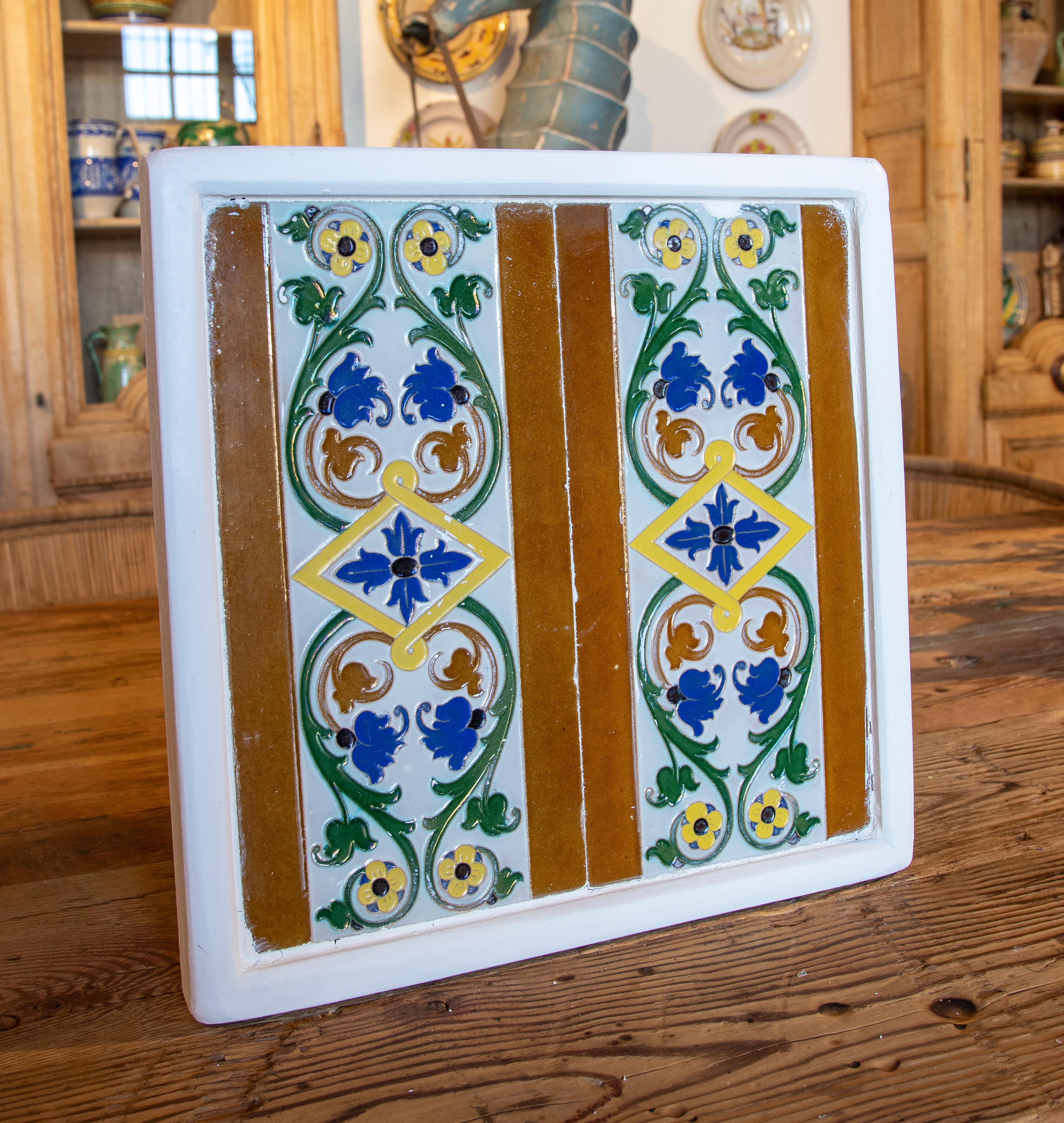 1950s Spanish decorative tile framed in wood in different colours.