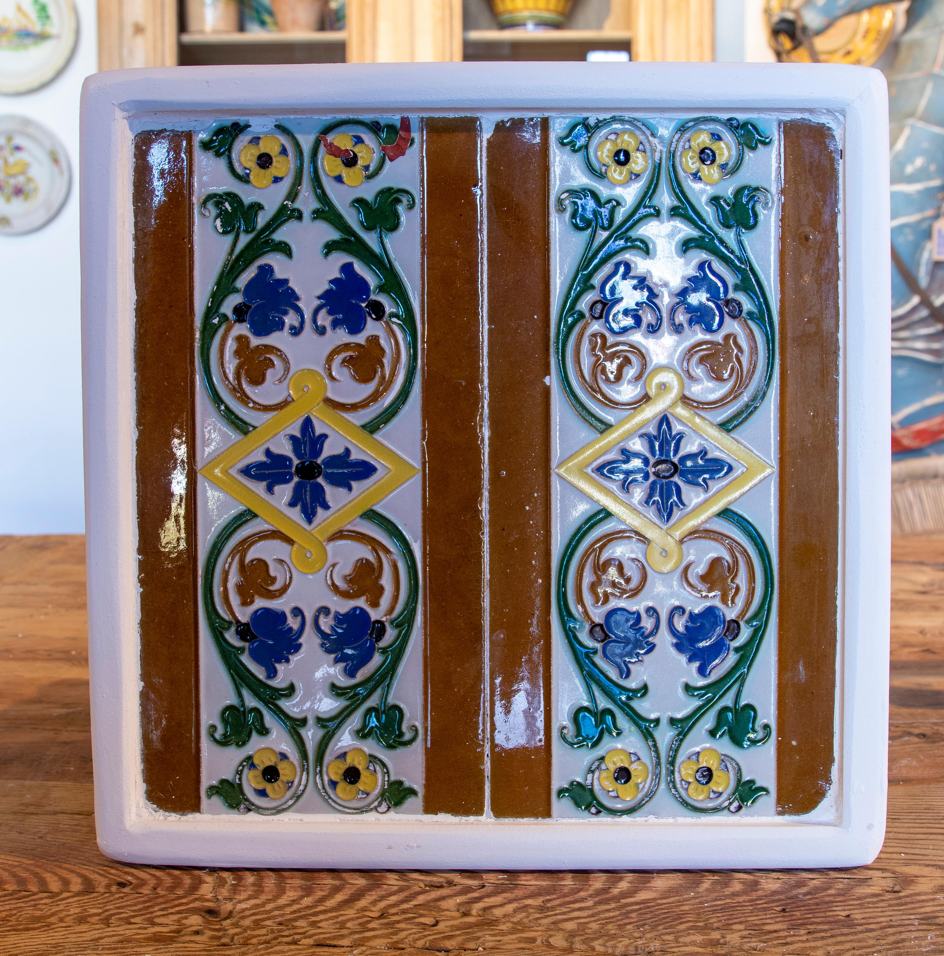 1950s Spanish decorative tile framed in wood in different colours.