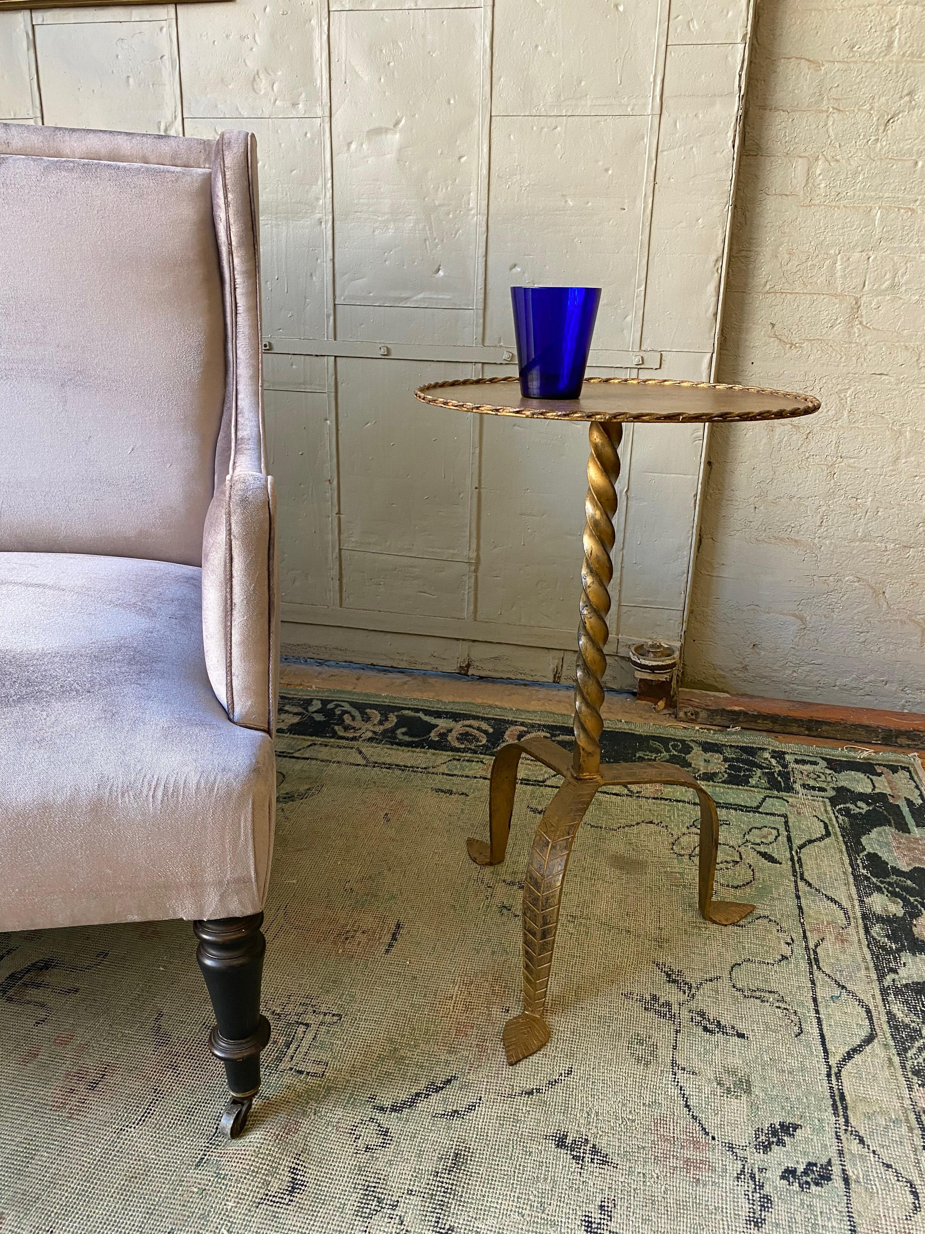 Very large gilt iron side table with a twisted stem on a tripod base. The top measures 15