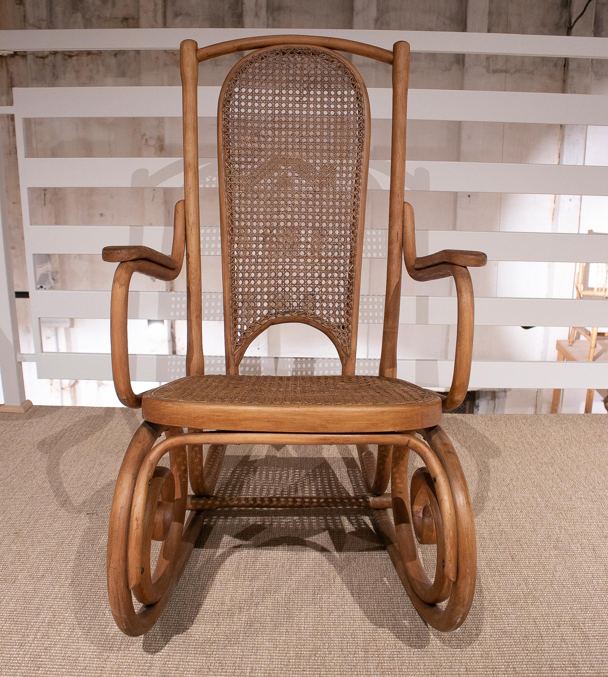 1950s Spanish hand woven wicker wooden rocking chair.