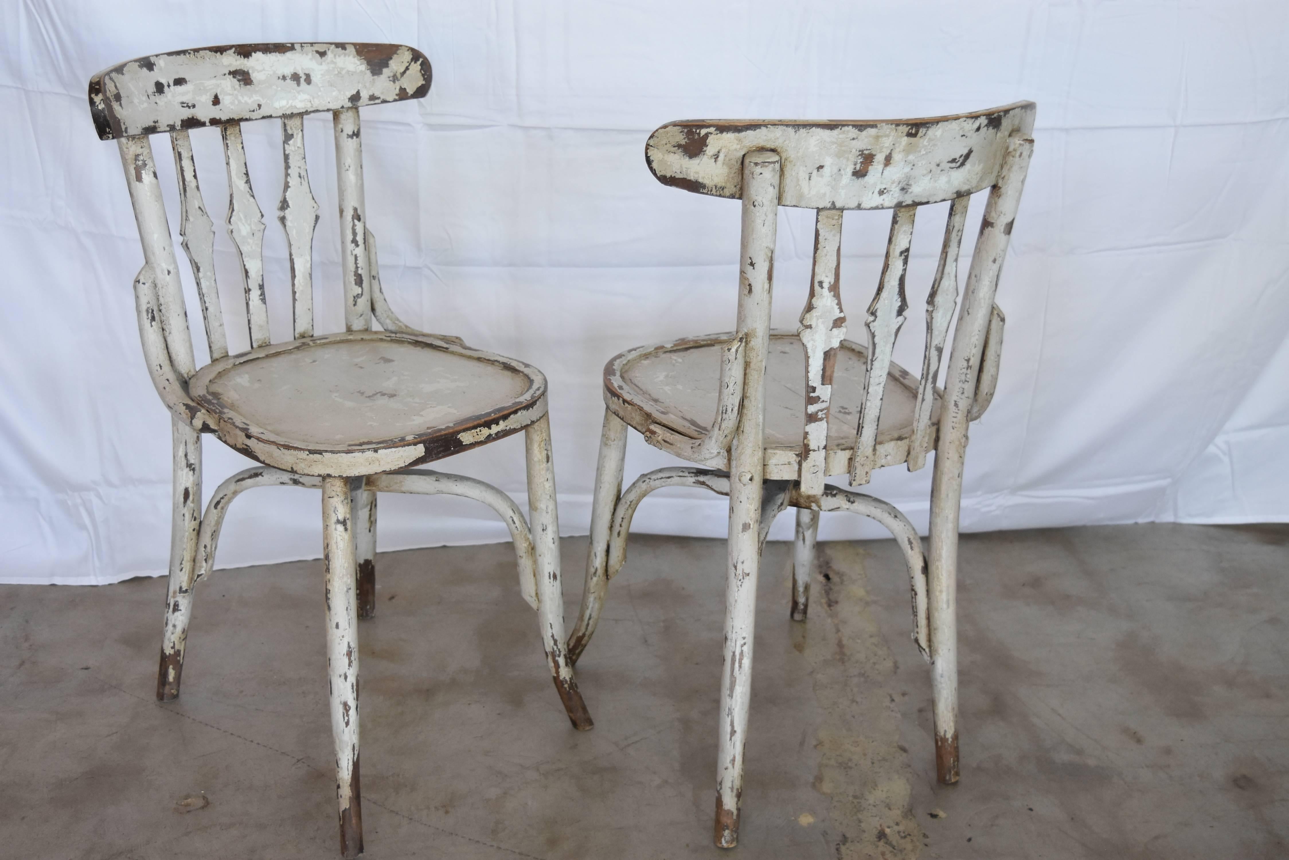 These bistro chairs from Spain are in excellent condition. They are a heavy duty wooden chair that has been hand painted with the prettiest light gray over white paint and waxed clear. I have several photos with details shown. Currently there are