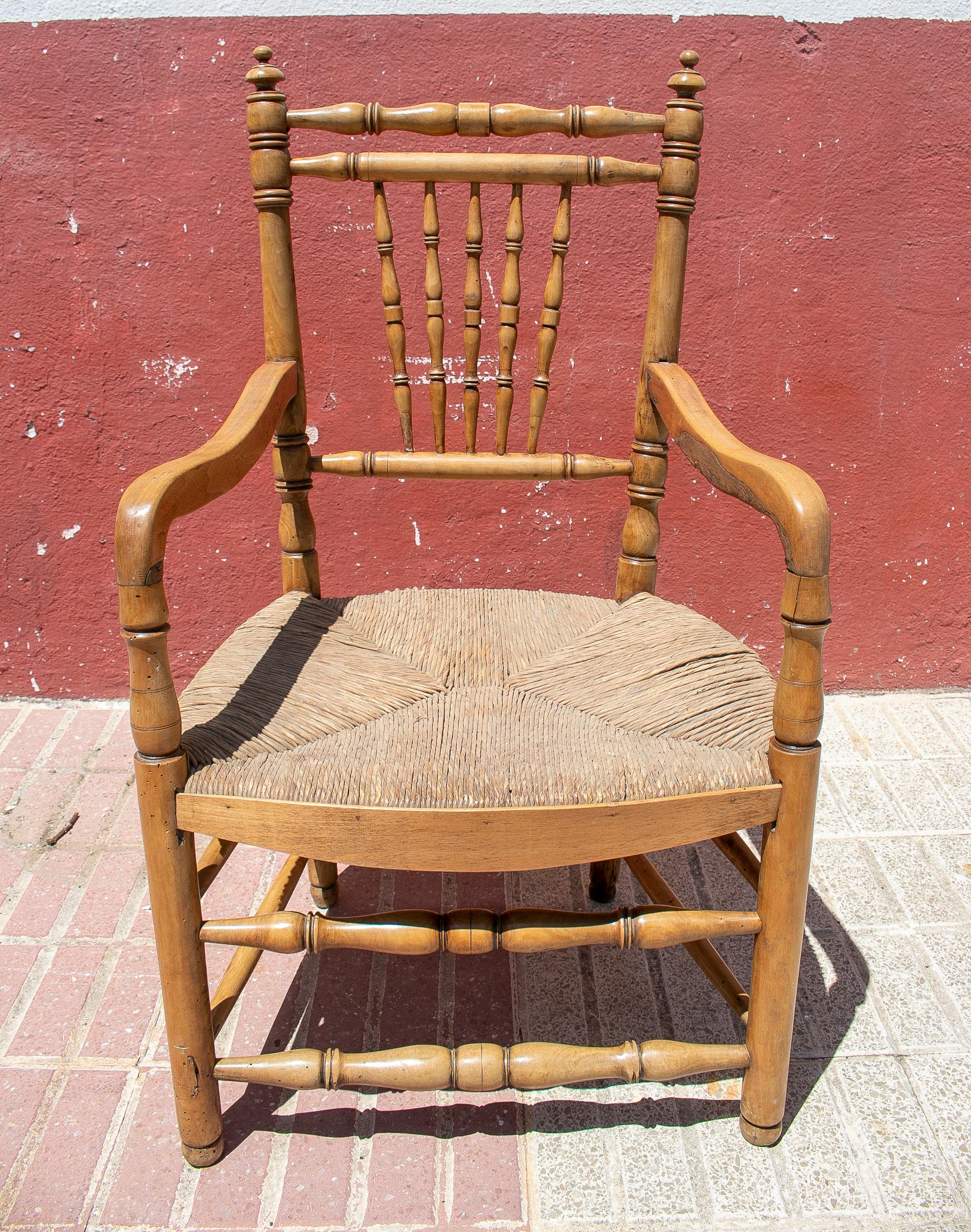 1950s Spanish woven rope bottomed wooden armchair with spindle legs.