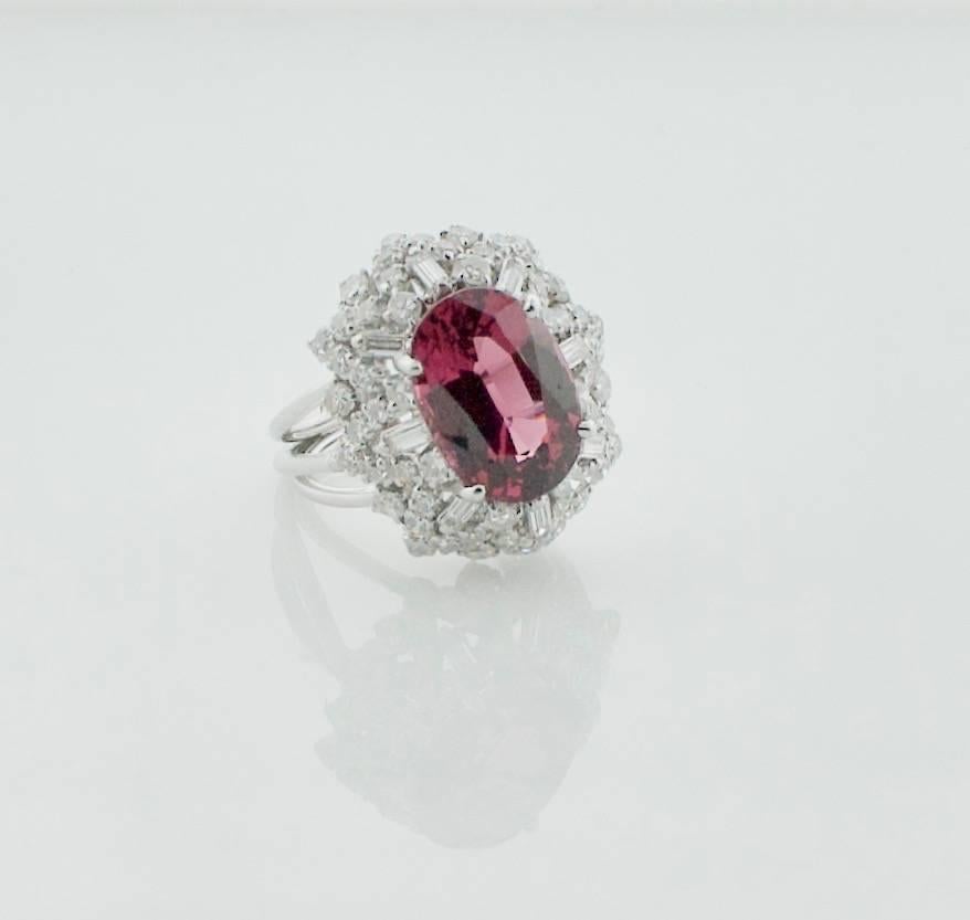 1950's Spinel and Diamond Cocktail Ring
One Oval Spinel 4.58 carats Bright with No Visible Imperfections to the Naked Eye of 10x Magnification  
Eight Baguette  Cut Diamonds weighing .40 carats approximately GH VS-SI1
Fifty Eight Round Brilliant Cut