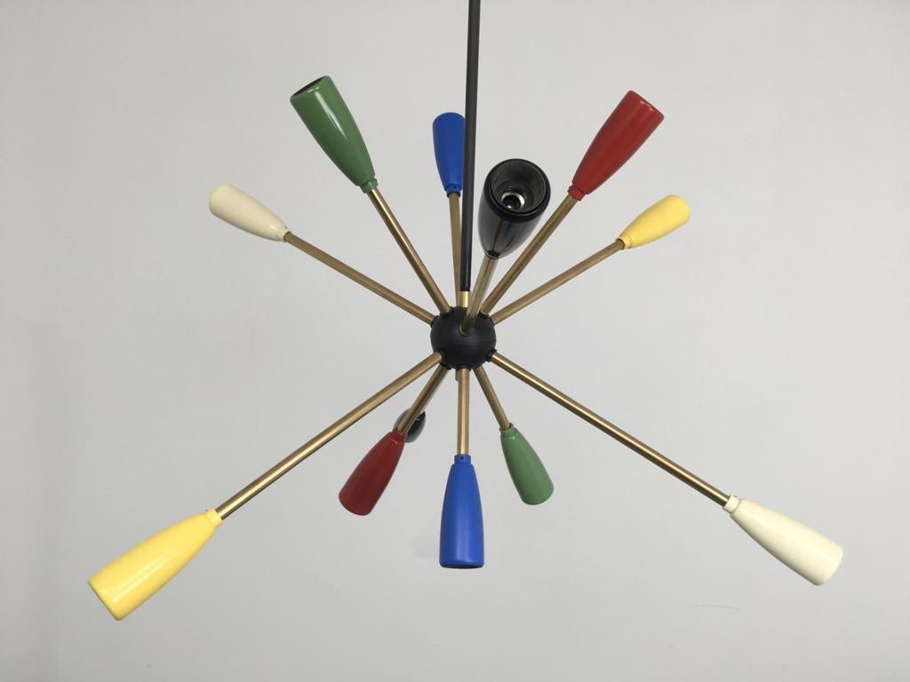 1950s Sputnik lamp in different colors. We have a couple of these Lamps in stock.

12 x E14 bulbs.
To be on the the safe side, the lamp should be checked locally by a specialist concerning local requirements.