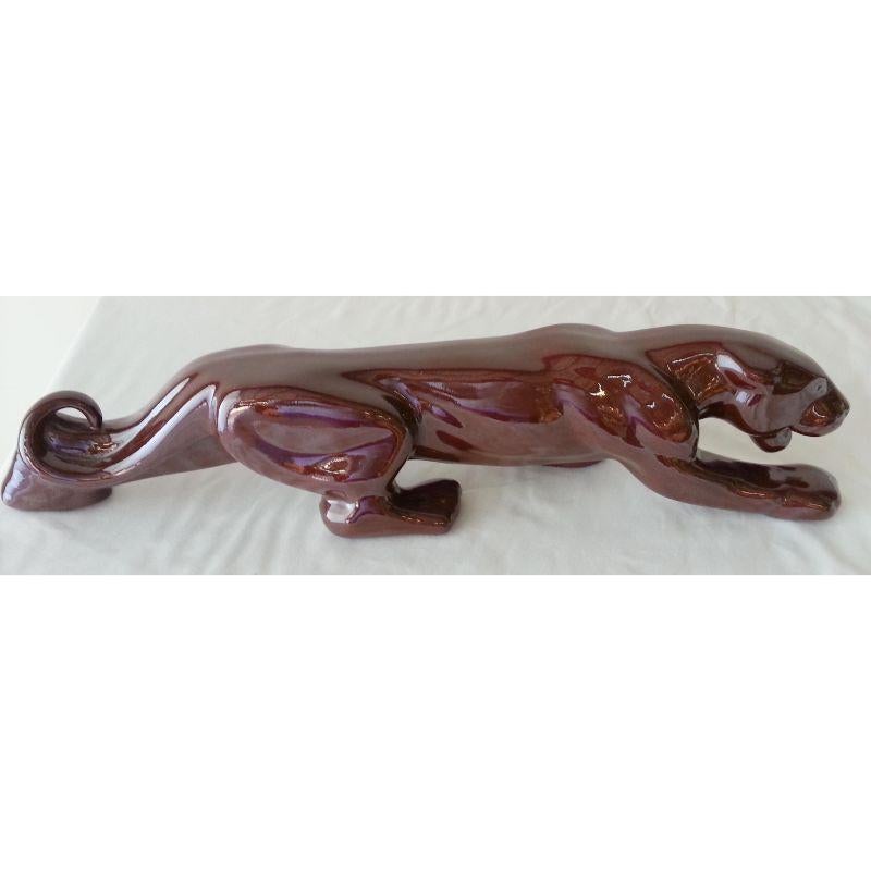 The stalking panther theme was one of the most popular subjects for Mid-Century TV Lamps and other decorative porcelain objects d'arte. This piece is a stand-alone statuette, finished in a high-gloss oxblood colored glaze. It's slender enough to