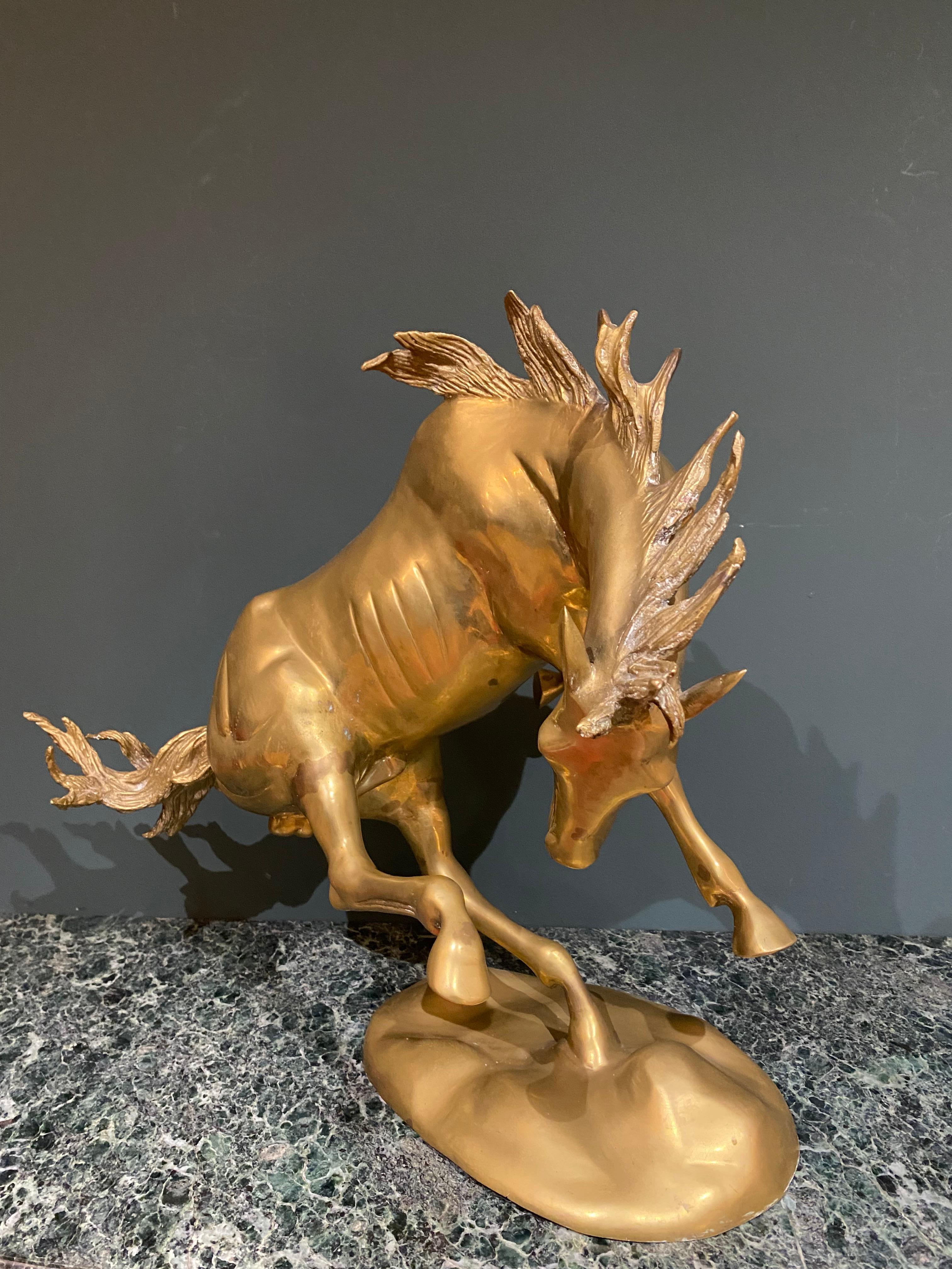 A beautifully detailed Italian brass sculpture of a stallion in motion.

 
