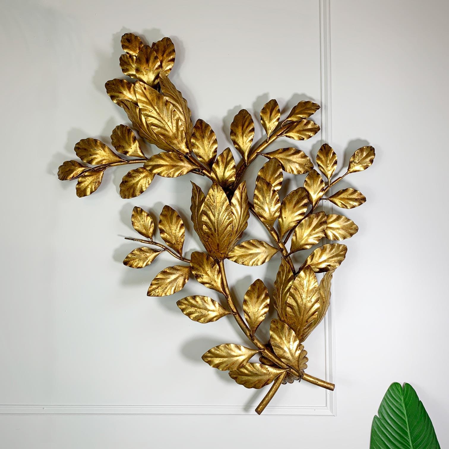 An incredible 1950s Italian Gilt leaf Wall sconce, the branch and leaf design are entirely gilded, and the light is of very large proportions, with 3 e14 (small screw in) lamp holders hidden behind the leaves. A beautiful piece, the design gives the