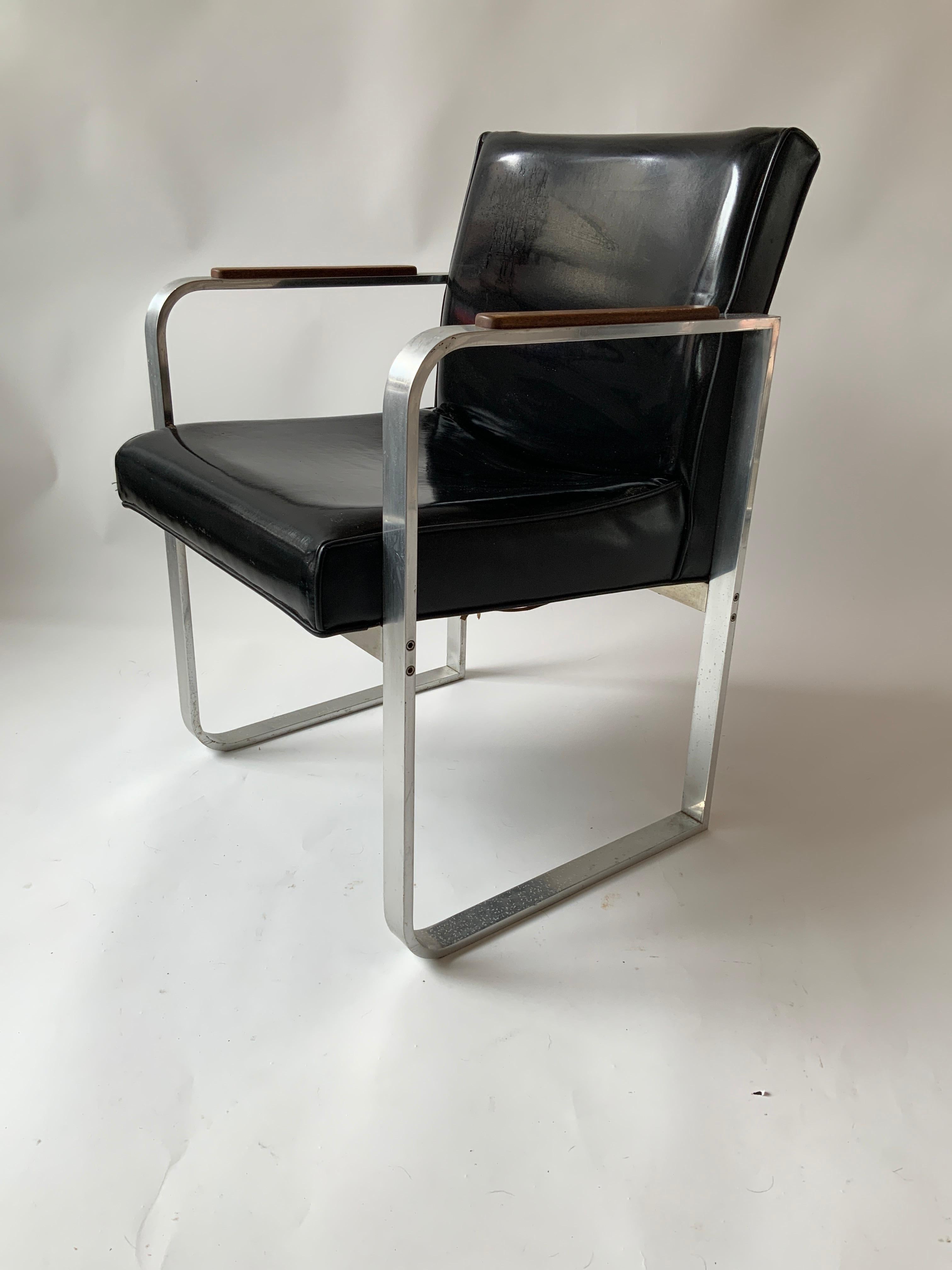 1950s steel armchair with wood armrests. Needs reupholstering. Steel needs polishing, some scratches as shown in last image.