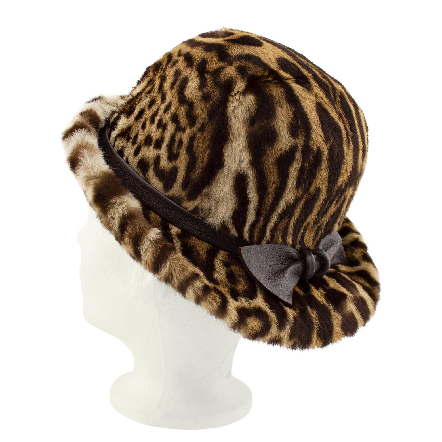 Beautiful 1950s stencil faux leopard print bowler style hat with brown leather bow. Brown silk lining. Made in Toronto, Canada. Excellent vintage condition. Fits small. Can be worn brim up or down.