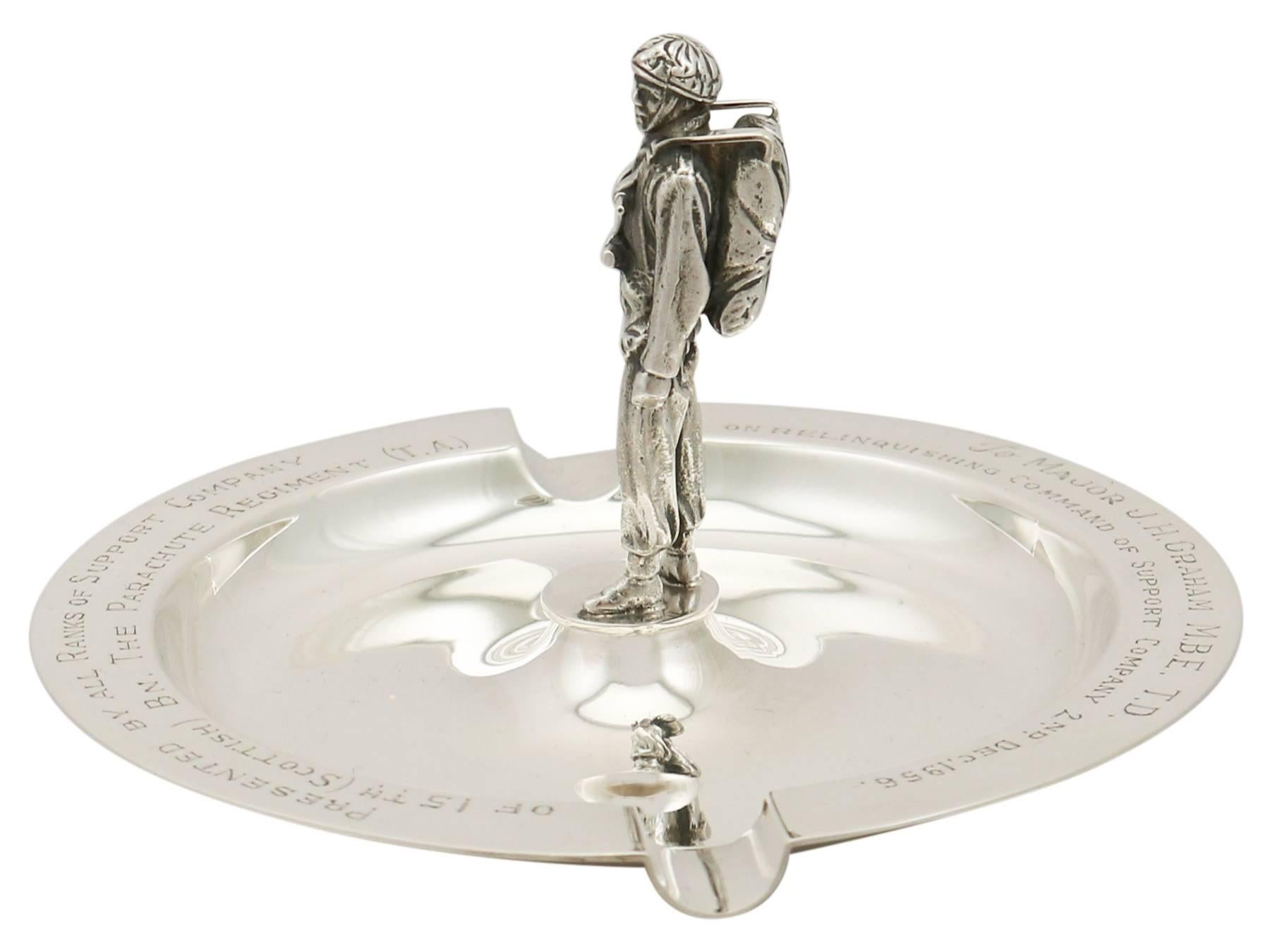 An exceptional, fine and impressive vintage Elizabeth II English sterling silver ashtray made by Garrard & Co Ltd; an addition to our military related silverware collection.

This exceptional vintage Elizabeth II sterling silver ashtray has a