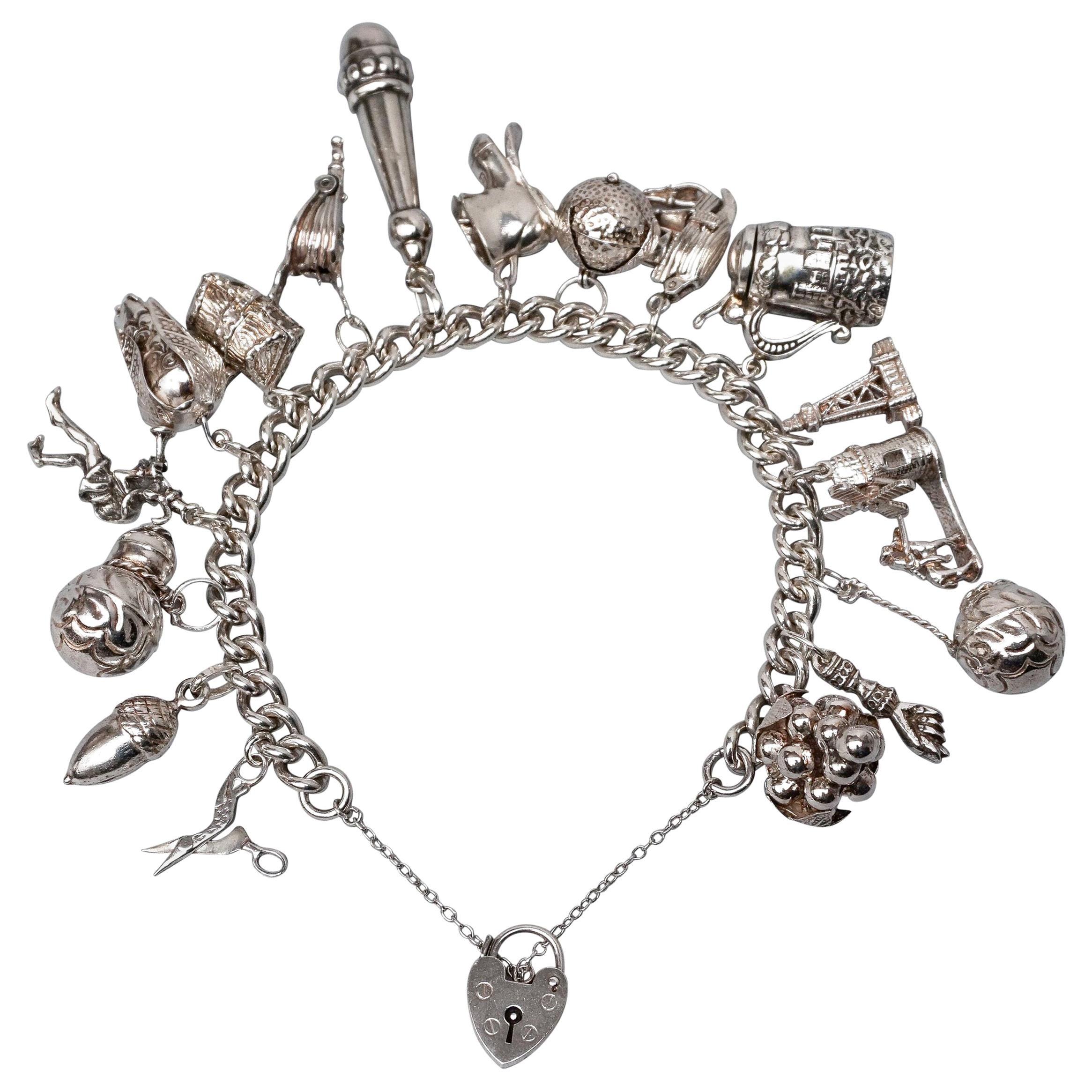 1950s Sterling Silver English Padlocked Charm Bracelet with Seventeen Charms For Sale