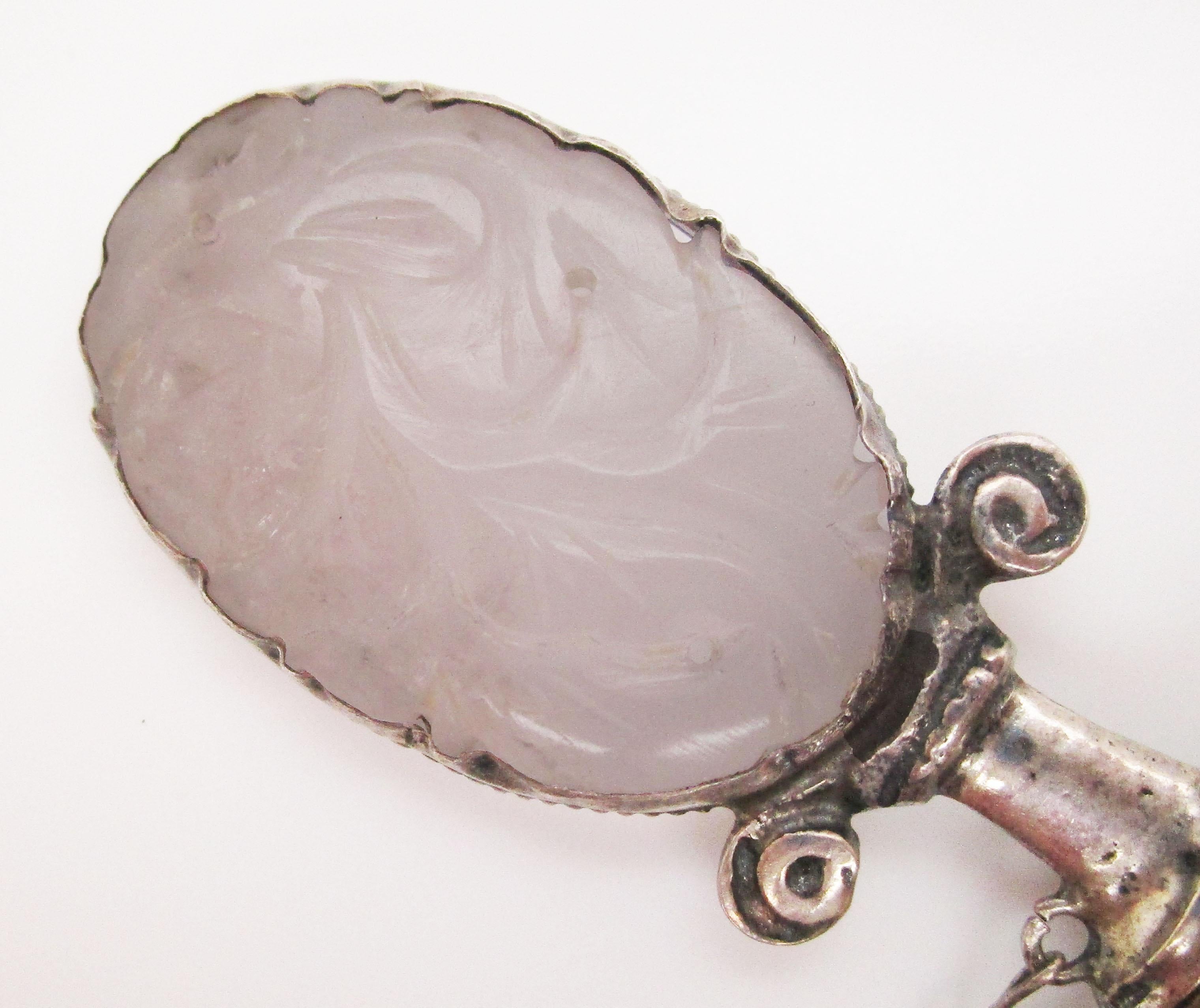 This sterling silver brooch brings together an epic combination of carved rose quartz and onyx to create an incredible piece of wearable art unlike anything you have seen! The sterling silver has been fashioned into the shape of a miniature blade,