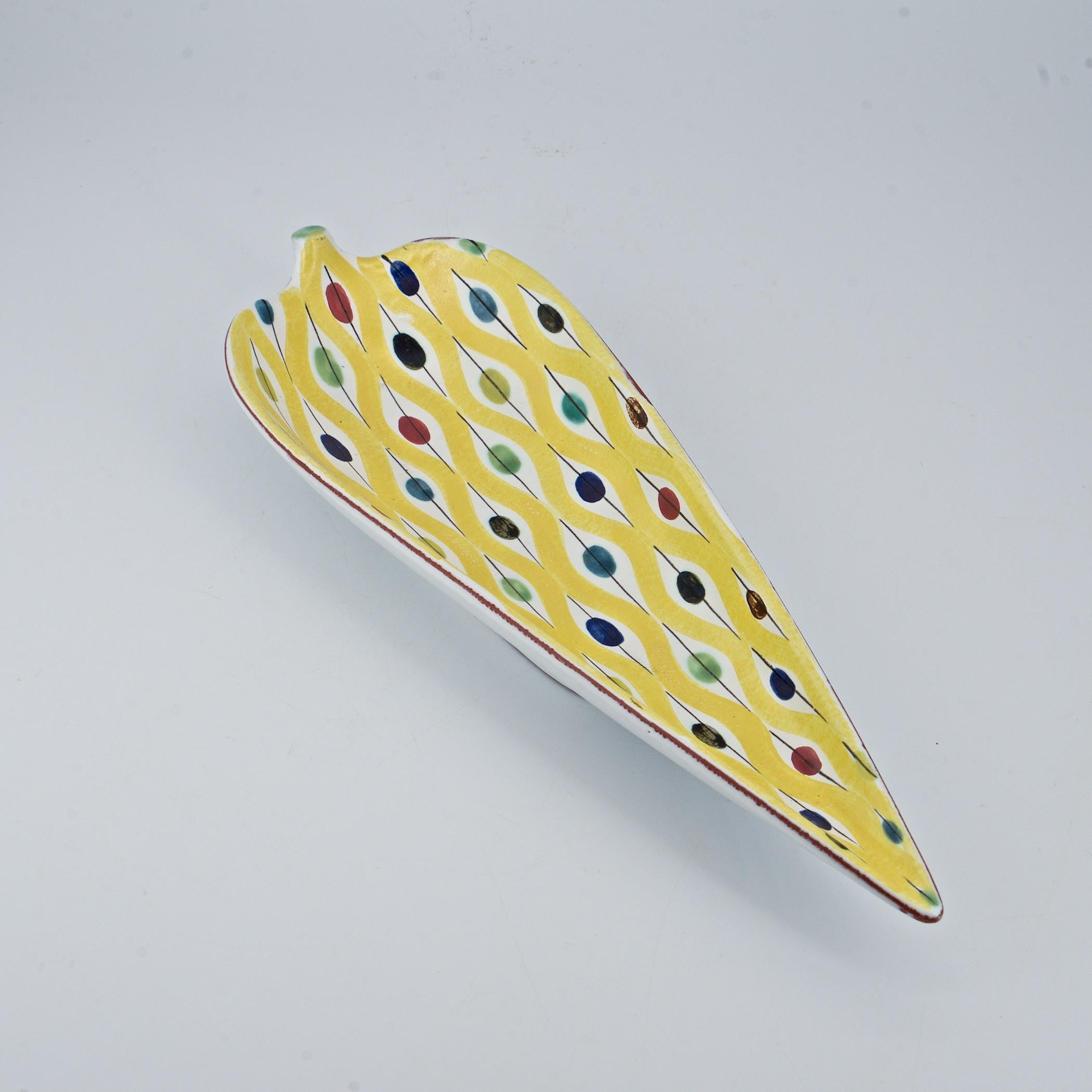 Wonderful and iconic Lindberg hand-painted pattern in lemon yellow. No chips, and no cracks, but there are some glaze skips to front left tip and rear side of stem, pictured. Just over 12 inches long.

