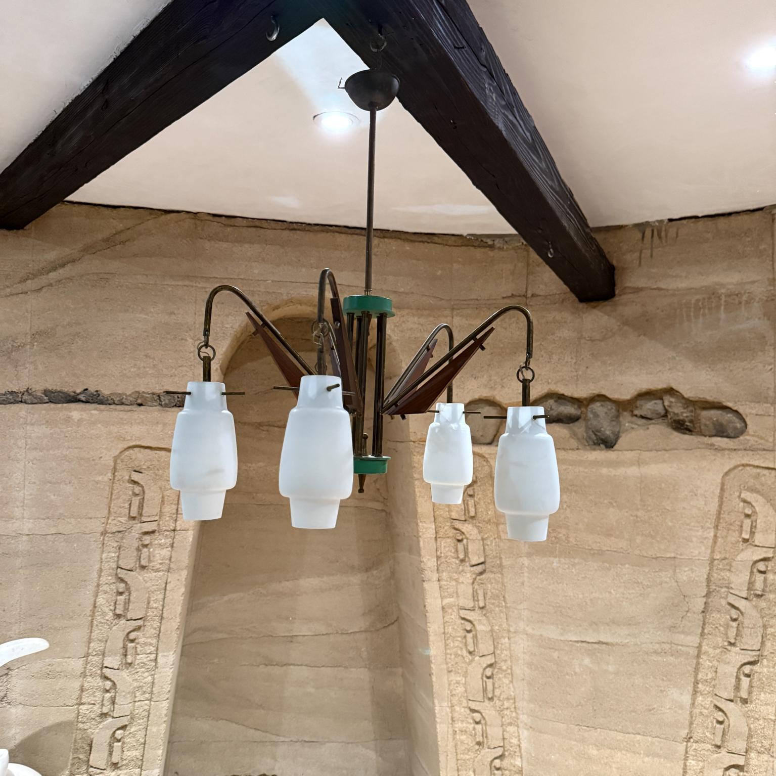 For your consideration, a Chandelier made in Italy circa 1950s. Style of Stilnovo with Five Light 
No label present. Attributed Stilnovo.
Brass and Wood Opaline Glass Green accent. 
Original Unrestored Vintage condition.
Requires 5 e-14 torpedo
