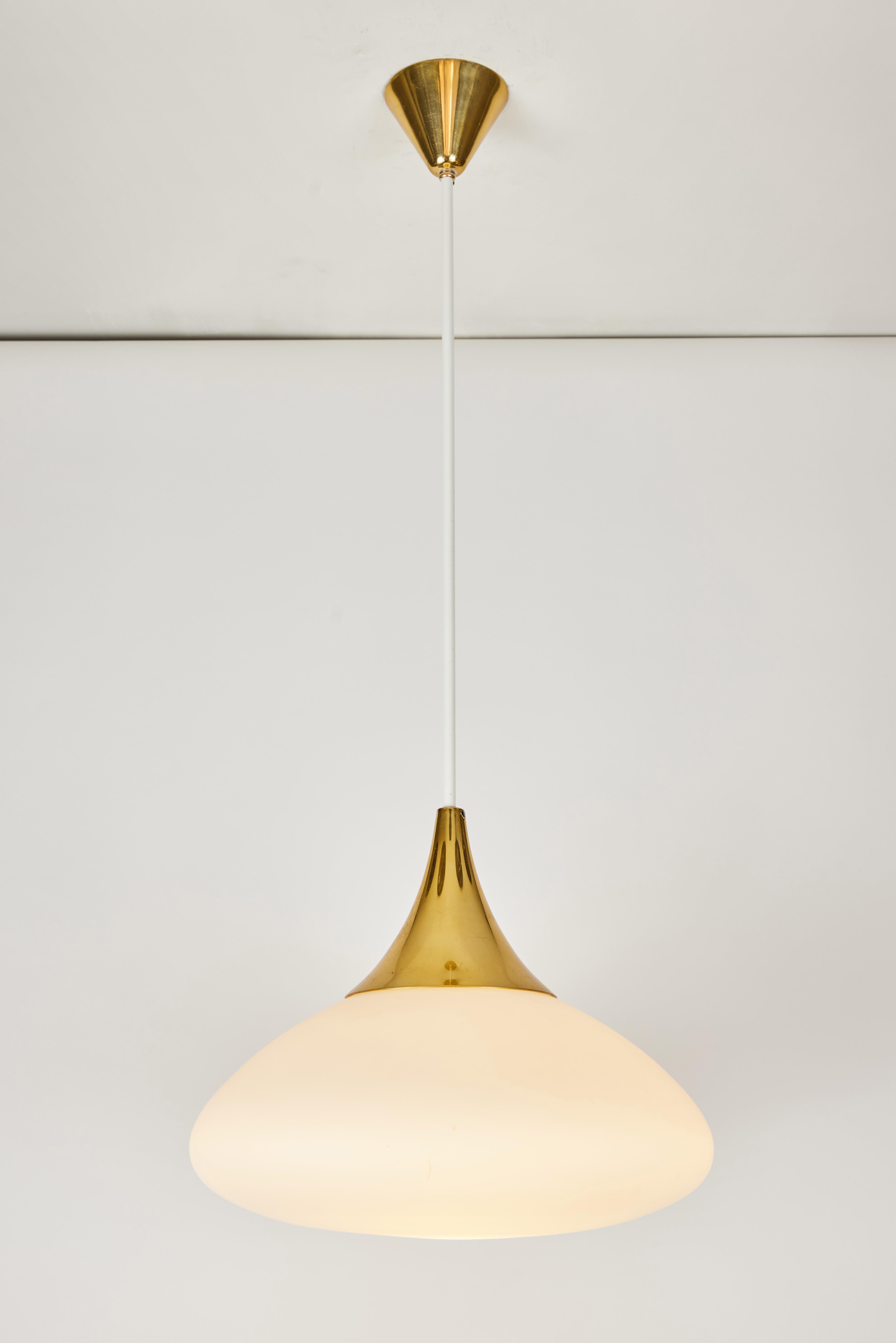 1950s Stilnovo glass and brass pendant. A quintessentially 1950s Italian design executed in matte finish opaline glass, painted metal and brass with original architectural ceiling canopy. A highly functional light sculpture of attractive scale and