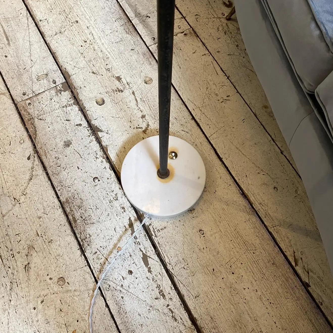An Italian floor lamp designed and manufactured in the Fifties by Stilnovo, marble base, black painted metal and brass are in original patina, white diffusor it's in perfect conditions. It works 110-240 volts and need regular bulbs.
This Floor Lamp