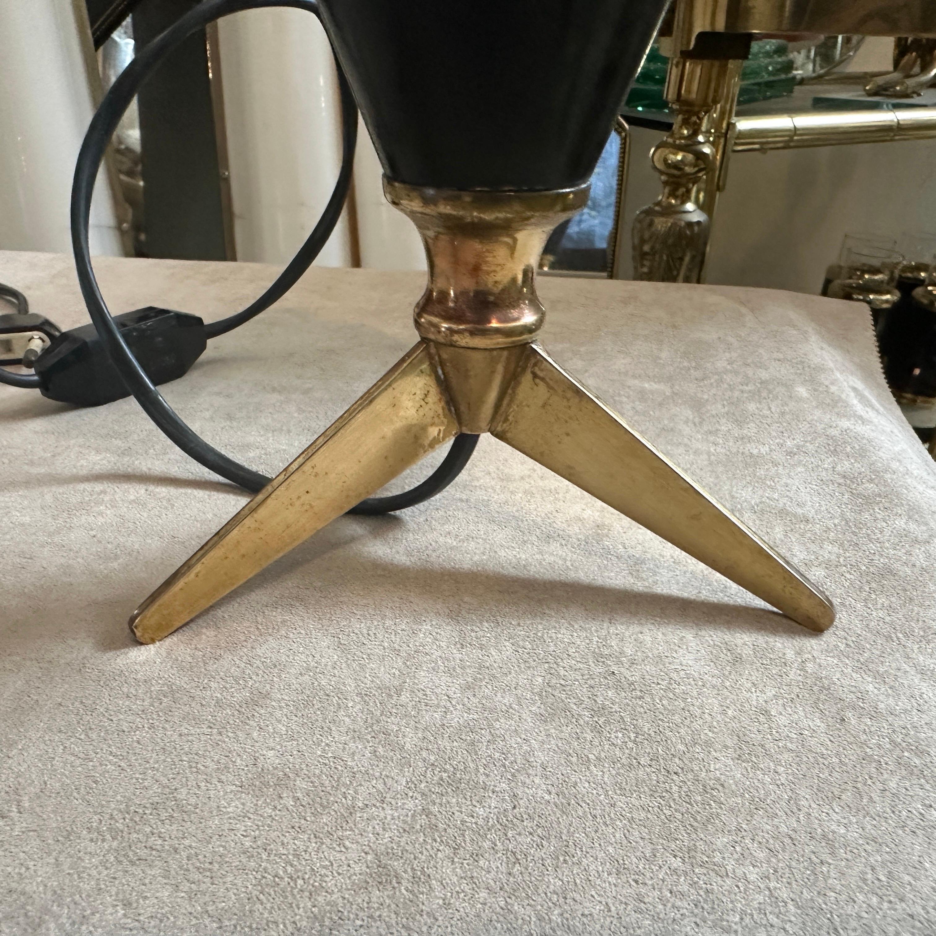 A sputnik table lamp designed and manufactured in Italy in the Fifties. The lamp it's in working order, brass it's in original patina, the black aluminum cone has signs of use and age all visible on the photos.  This lamp represents an iconic era in