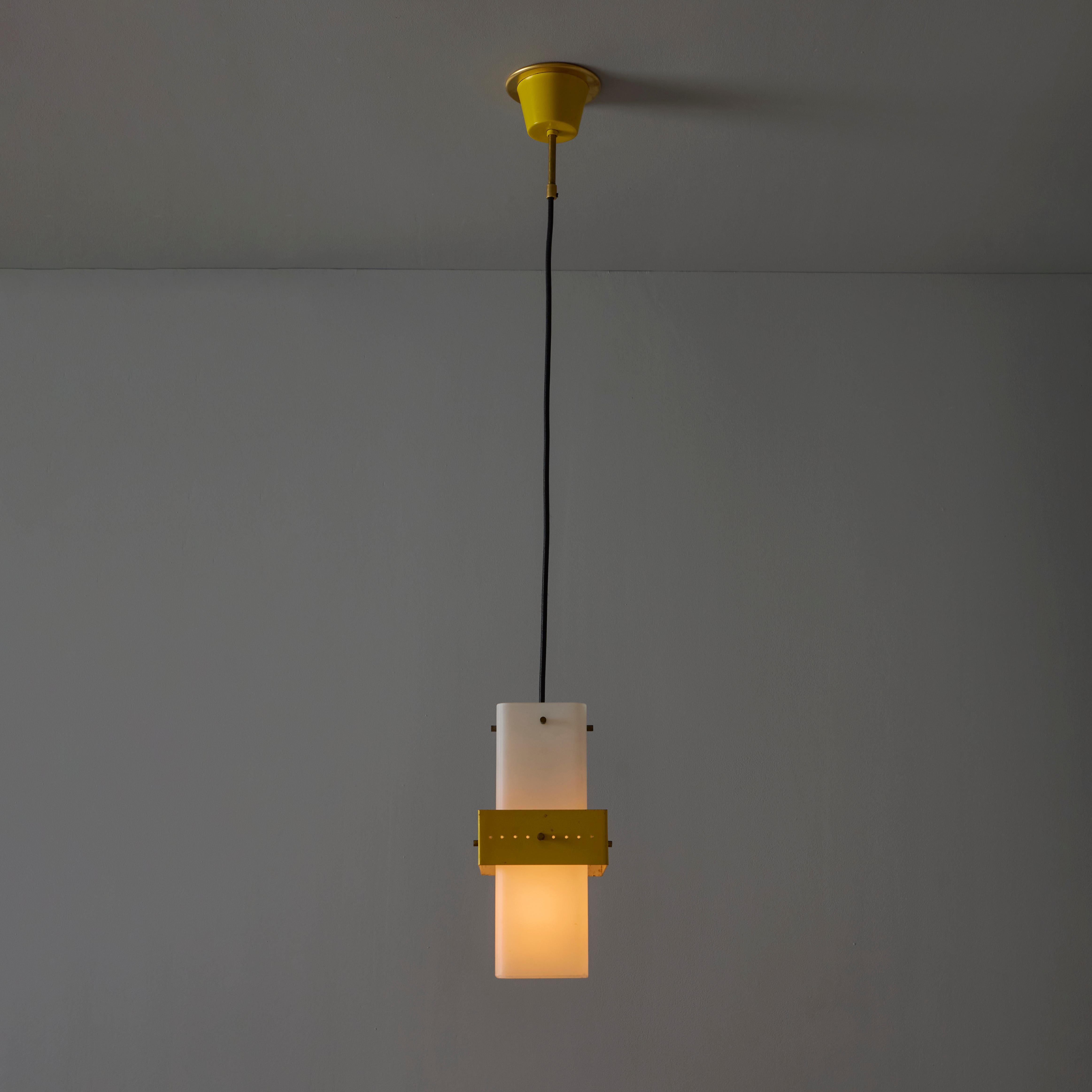 1950s Stilnovo Yellow Painted Metal & Opaline Glass Suspension Lamp

A quintessentially 1950s Italian design executed in sculptural opaline glass, yellow painted metal, and brass hardware. A highly functional and refined suspension light of