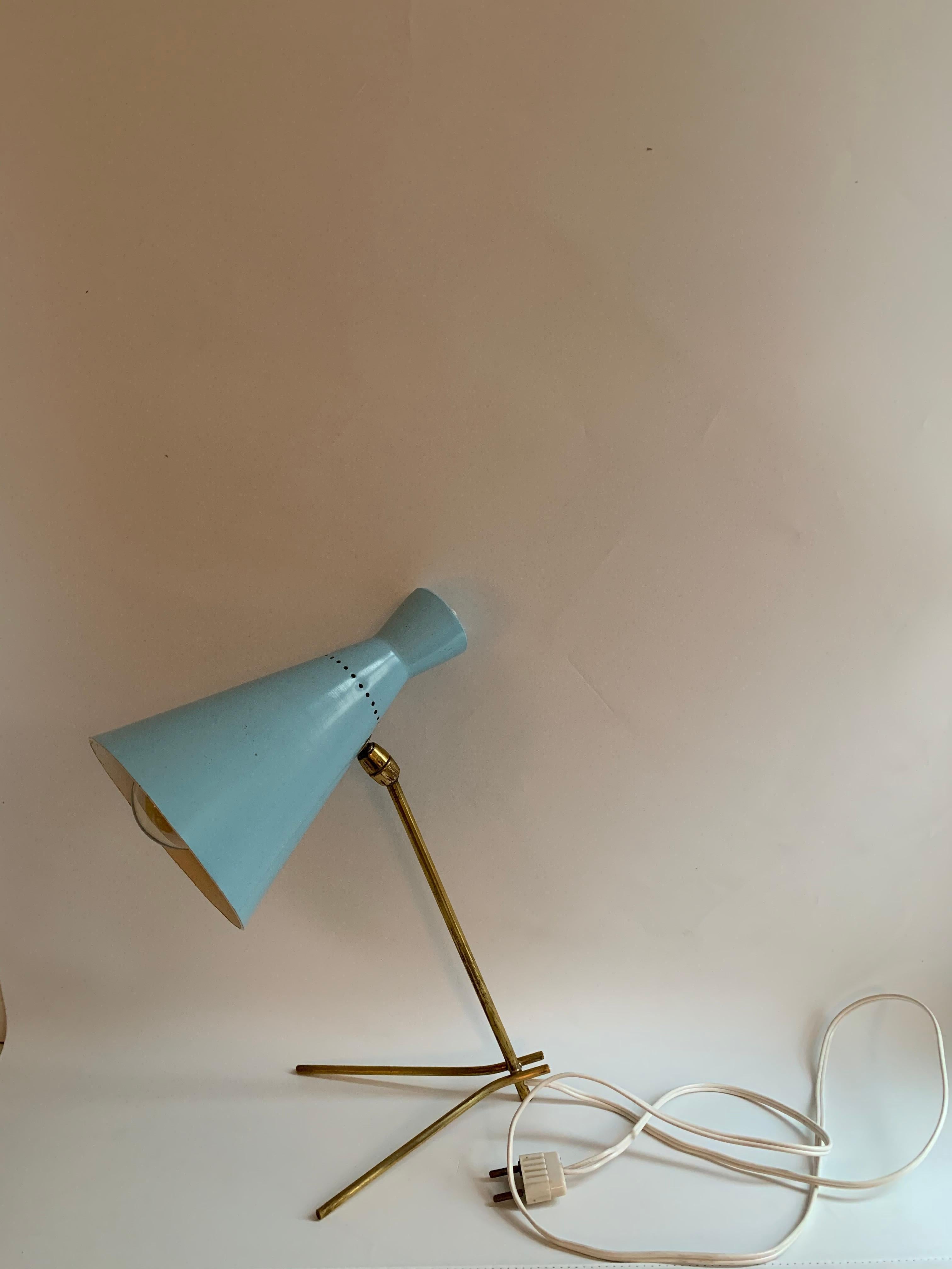 1950s Stilux Milano light blue and brass table lamp. This extremely rare and iconic design is executed in light blue paint and has a messing foot, with original color, and EU wiring in excellent vintage condition. Shade adjustable at two points for