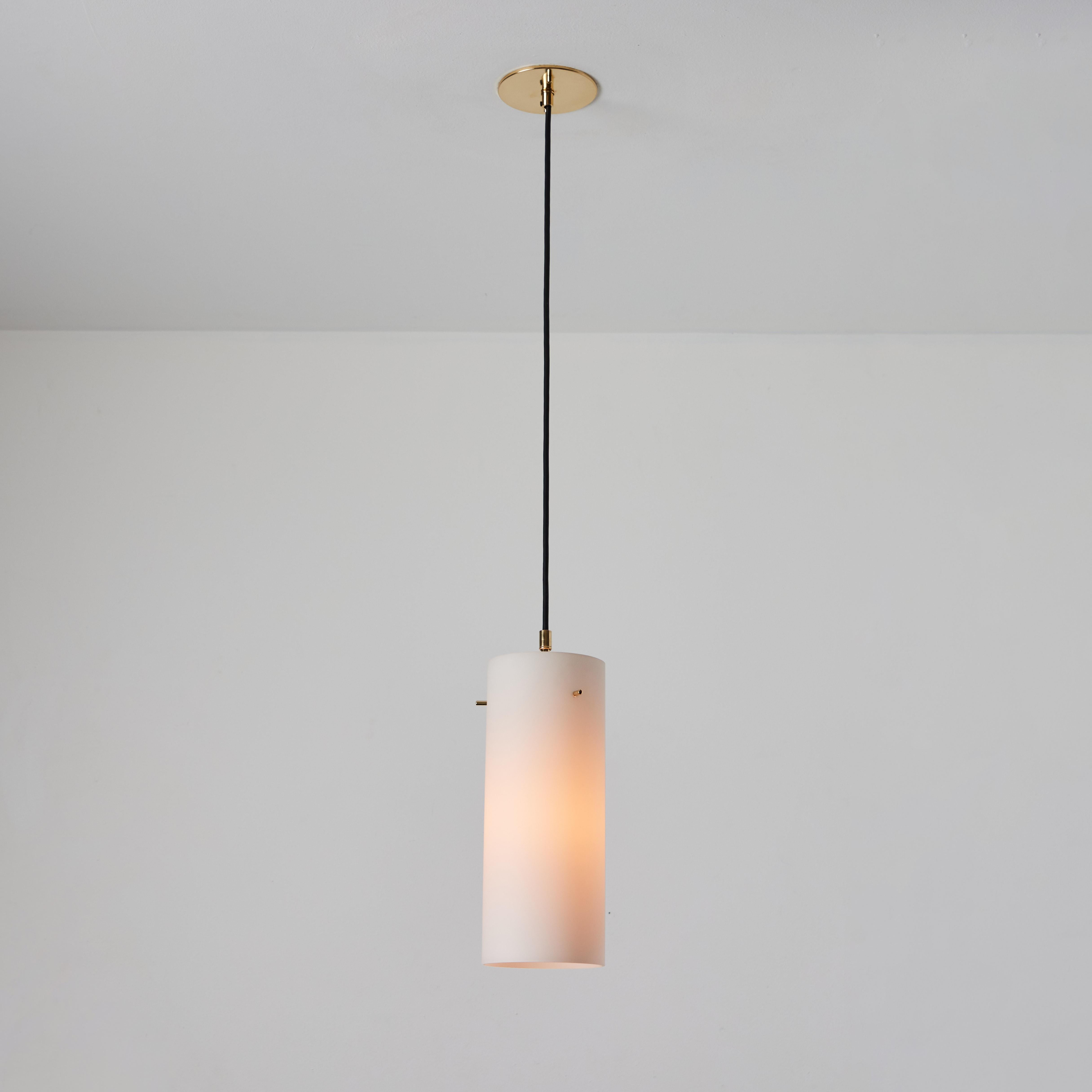 1950s Stilux Milano Opaline Glass & Brass Pendant. Executed in sculptural cylindrical opaline glass with brass hardware. A highly refined ceiling lamp light of attractive scale and incomparable refinement. Unmarked.

Stilux was one of the most