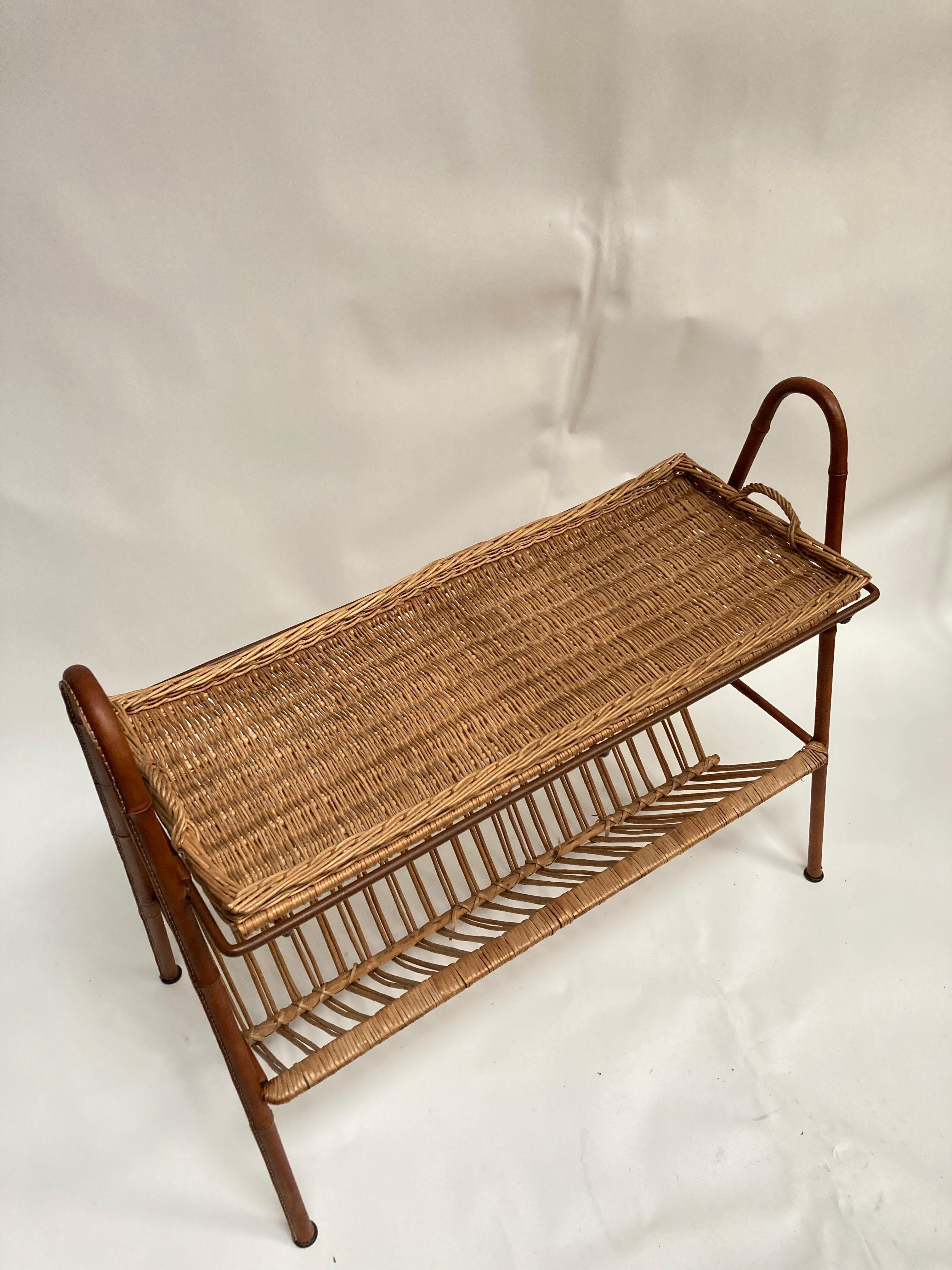 1950's Stitched leather and rattan table by Jacques Adnet
The higher top is a tray with two handles on each side
Leather is in great condition
Rattan have a small accident on the low part 
Overall great condition
