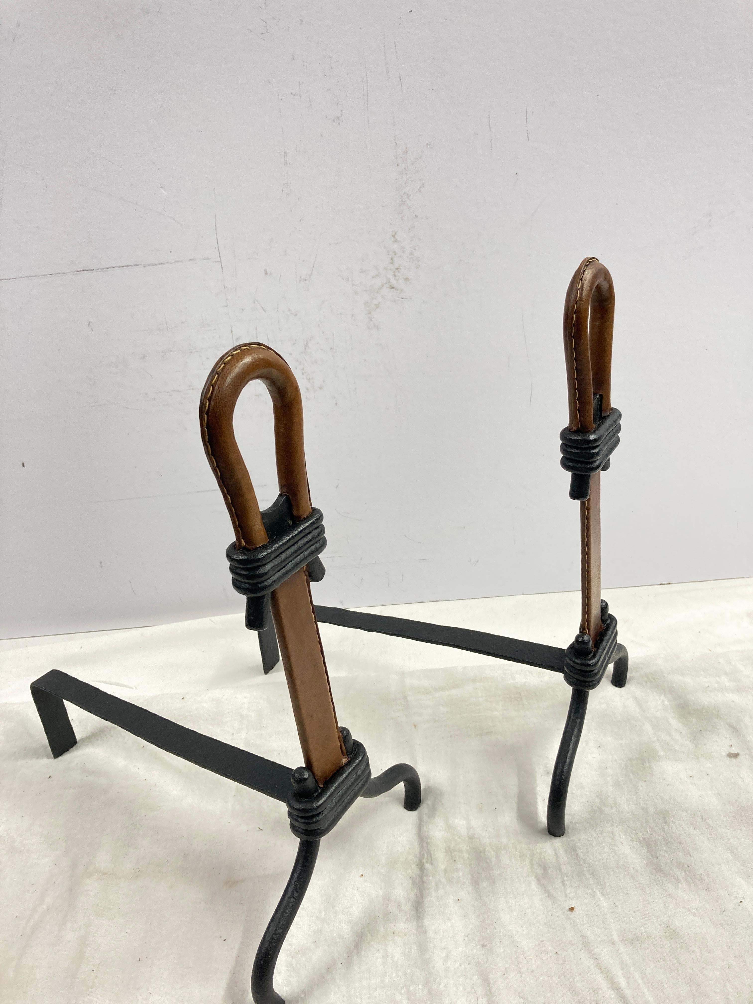 Metal 1950's Stitched leather andirons by Jacques Adnet For Sale
