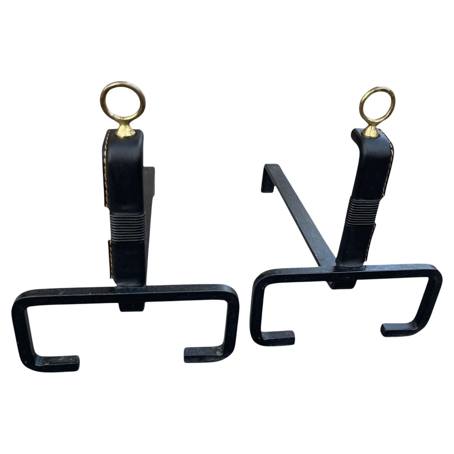 1950
s Stitched leather andirons by Jacques Adnet