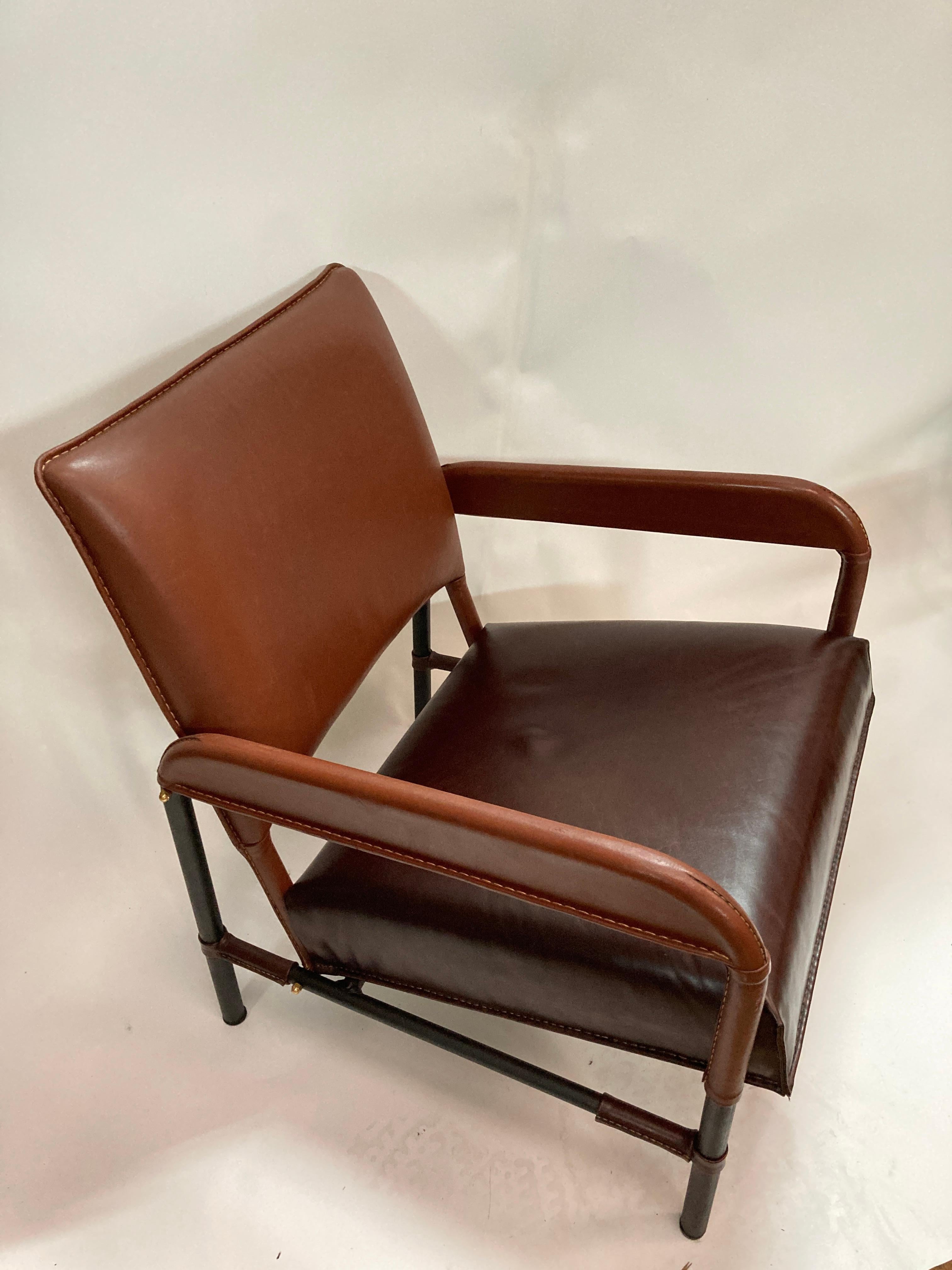 1950's stitched leather armchair by Jacques Adnet
Made for transatlantic and air France company 
Bi-color of brown leather
Great condition
