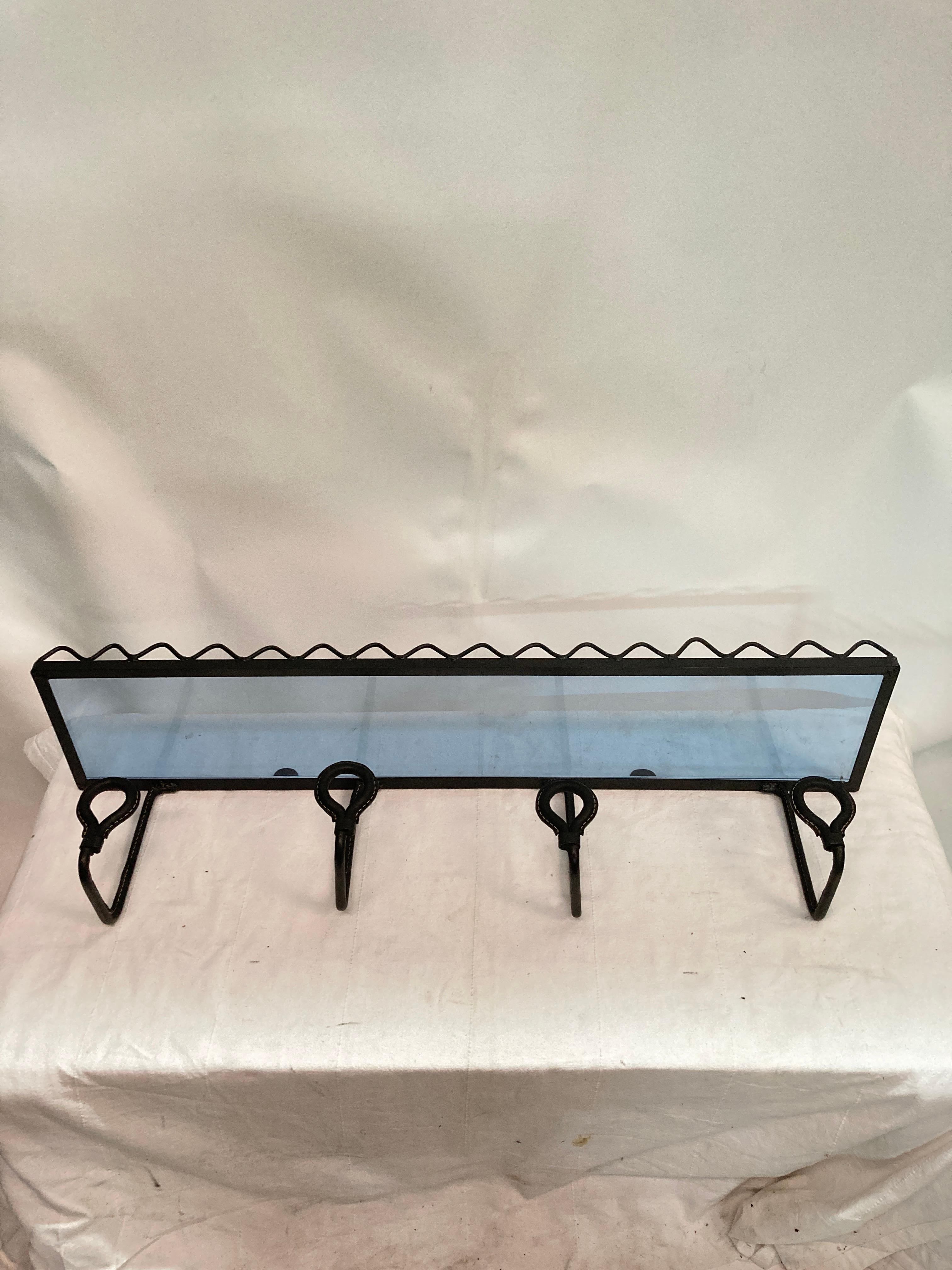 1950's Stitched leather coat rack by Jacques Adnet
with blue Saint-Gobain glass