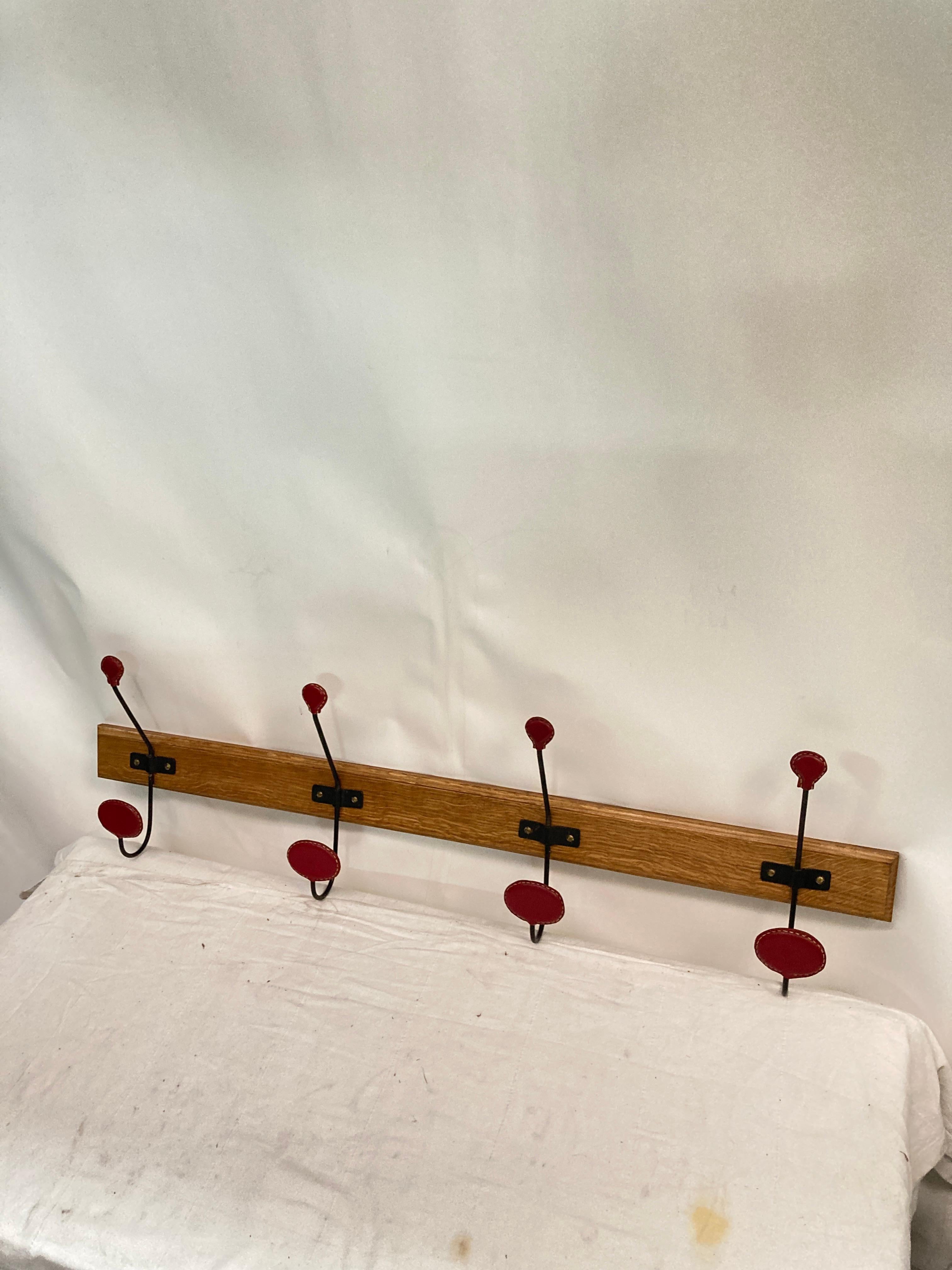 1950's Stitched leather and oak coat rack by Jacques Adnet
France