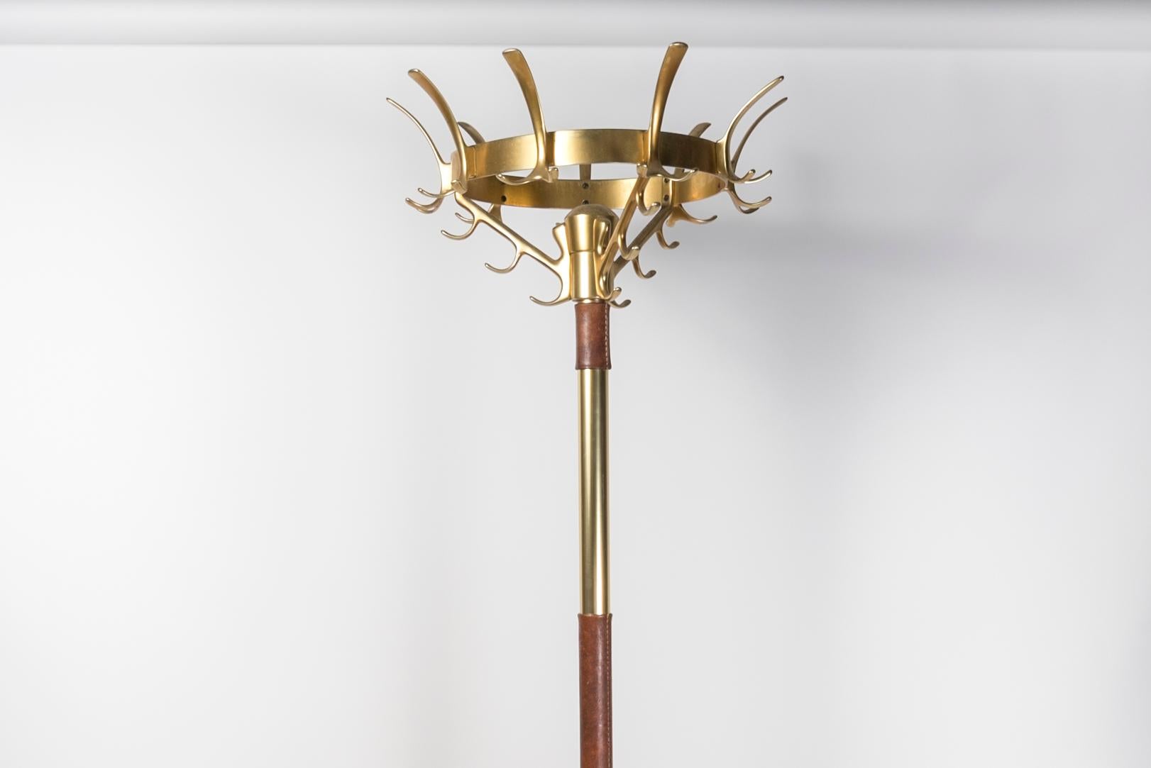 1950's brass and stitched leather coat stand by jacques Adnet.

