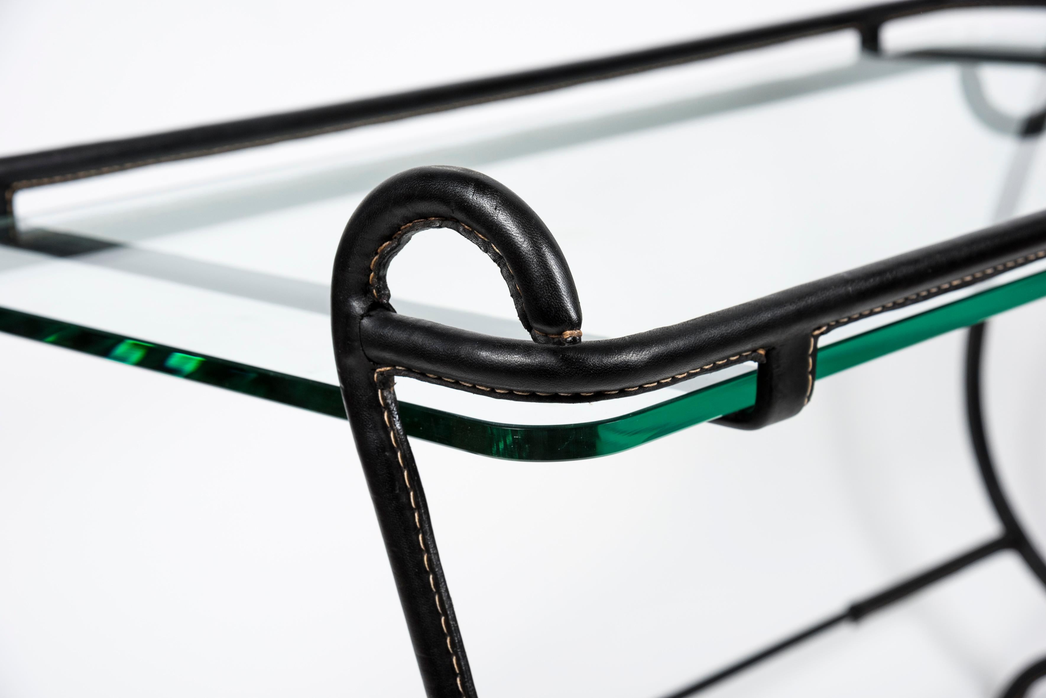 1950s stitched Leather cocktail table designed by Jacques Adnet
France

Measures: Total High, not to the glass top 60 cm.