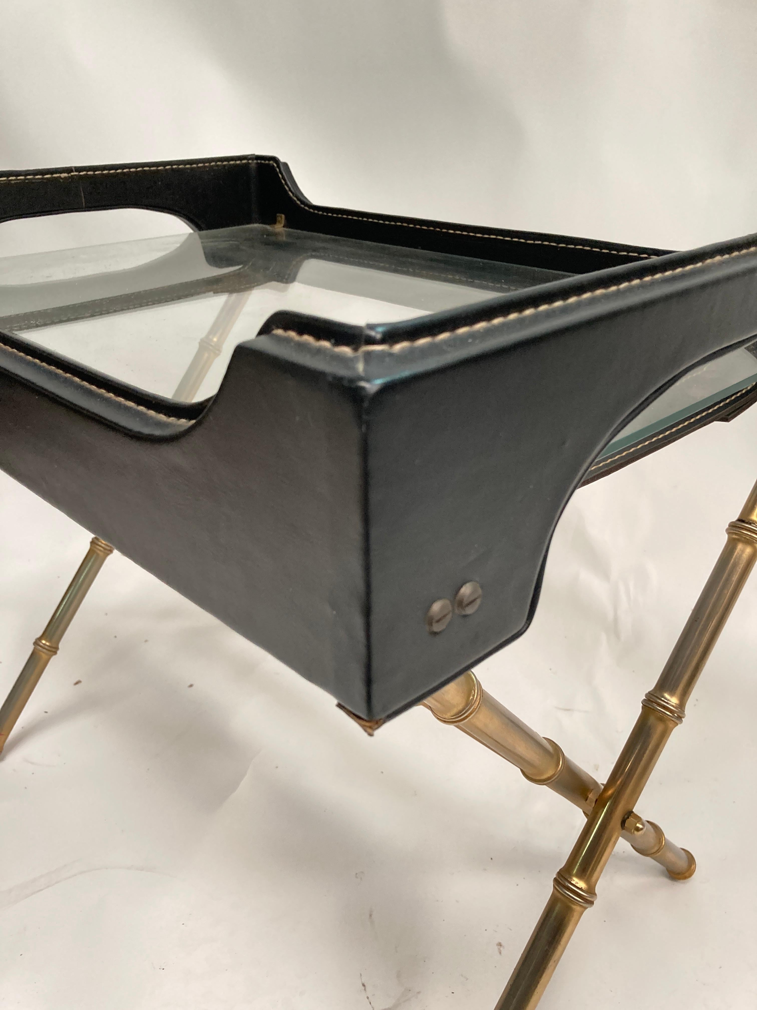 1950's Stitched leather cocktail table.
The top is a tray, the base can be folded
This piece is quiet rare complete on the market particularly in this condition