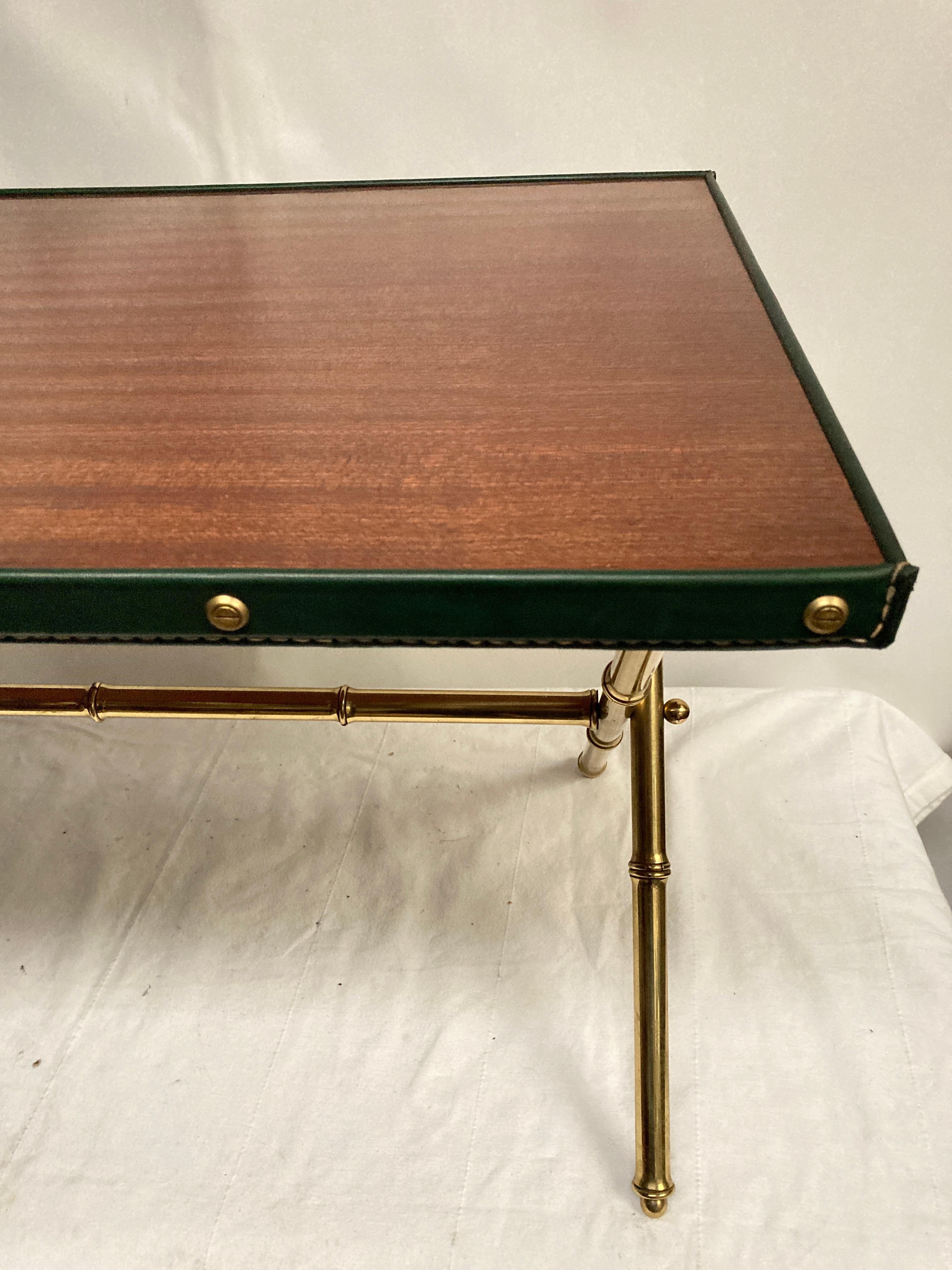 1950's Stitched leather cocktail table or side table
Brass bambou feet . Green leather
Great condition
