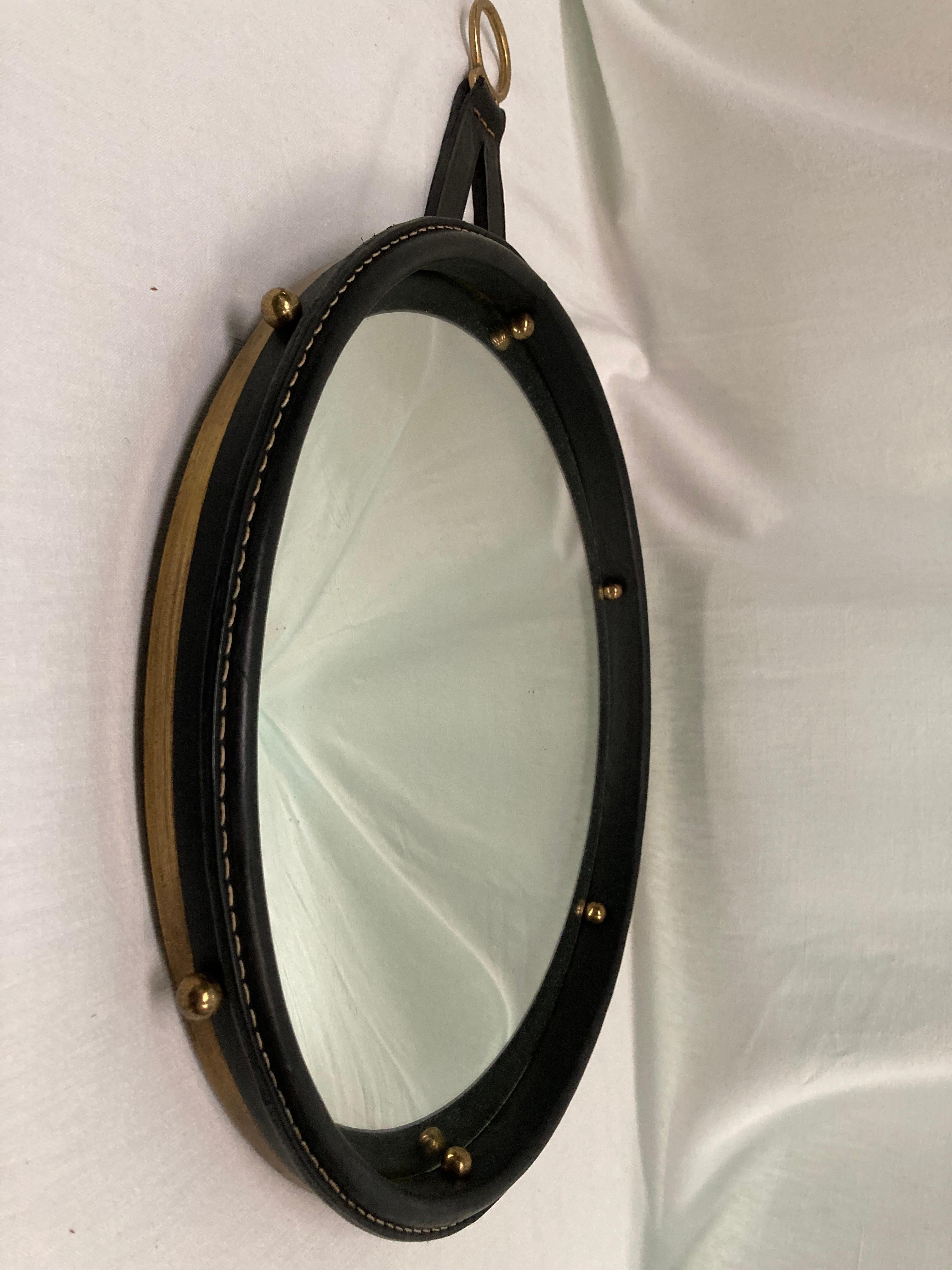 1950's wall convex mirror by Jacques Adnet
Great condition
Leather and brass
Rare piece

