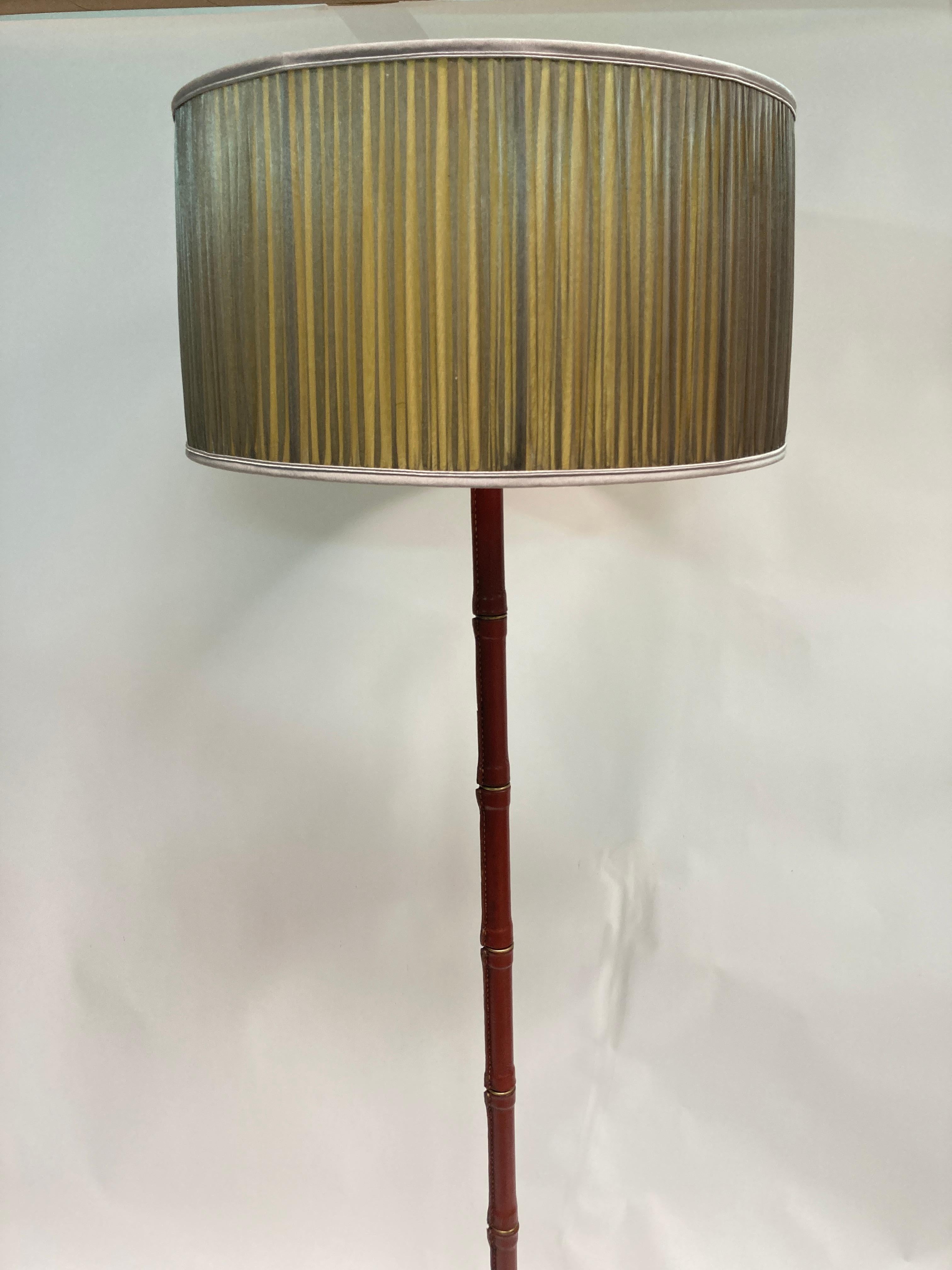 Rare 1950's Stitched leather floor lamp by Jacques Adnet 
All covered with brown leather  with brass part on feet
Great vintage condition