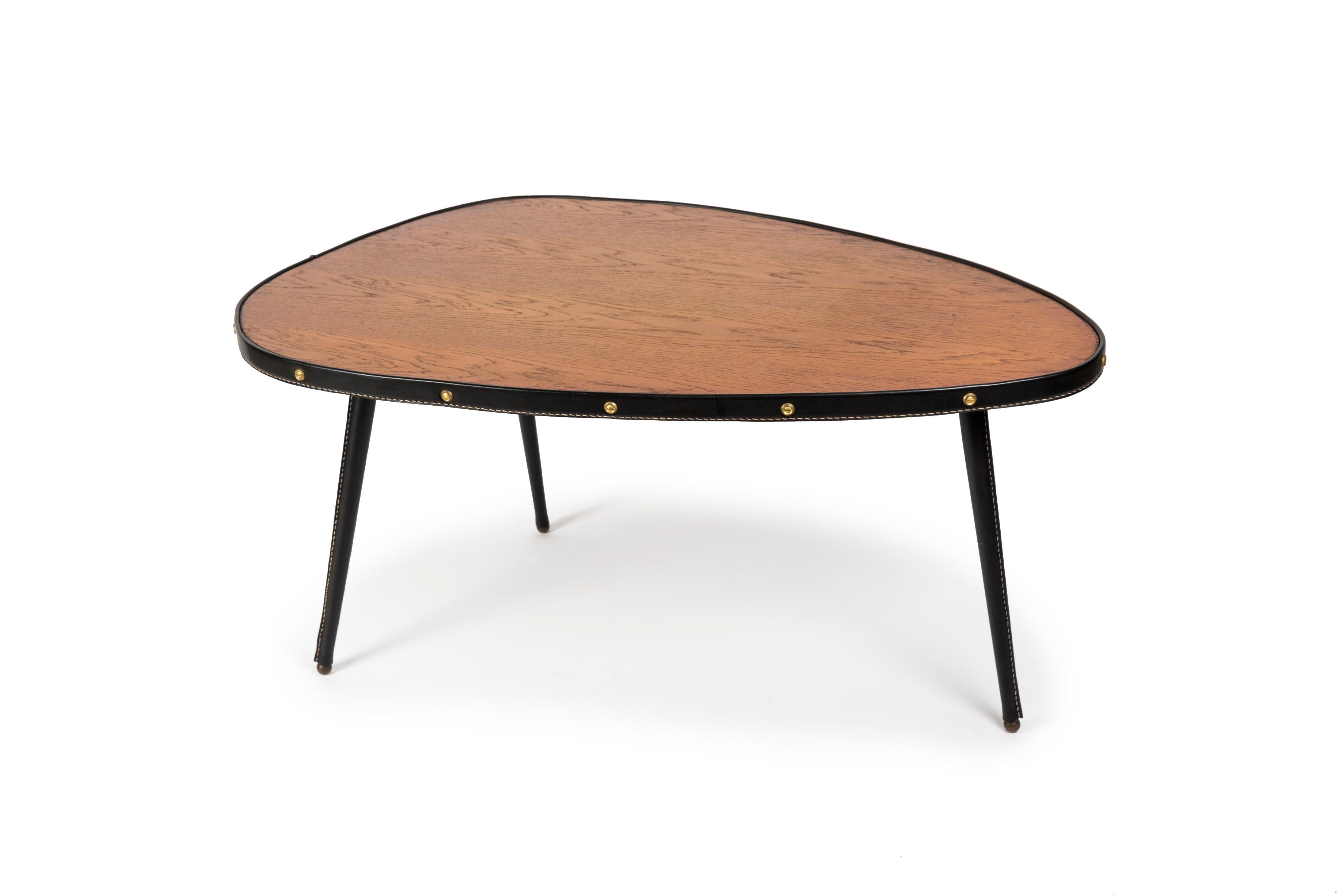 1950's Stitched leather and oak cocktail table
Rare with this shape 
France