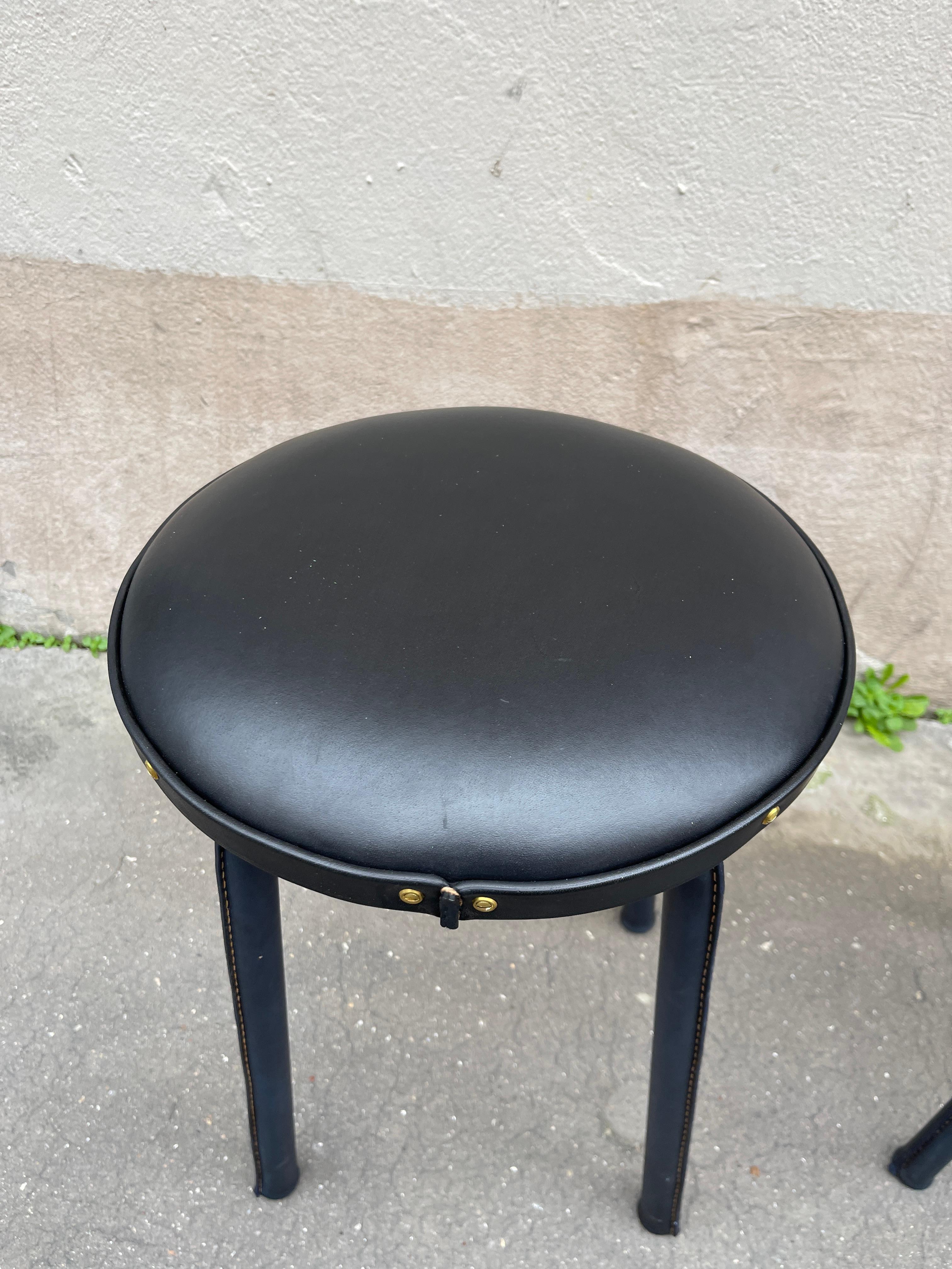Leather 1950's Stitched leather pair of stools by Jacques Adnet For Sale