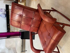 Silla mecedora y otomana de cuero cosido de los años 50, por Jacques Adnet