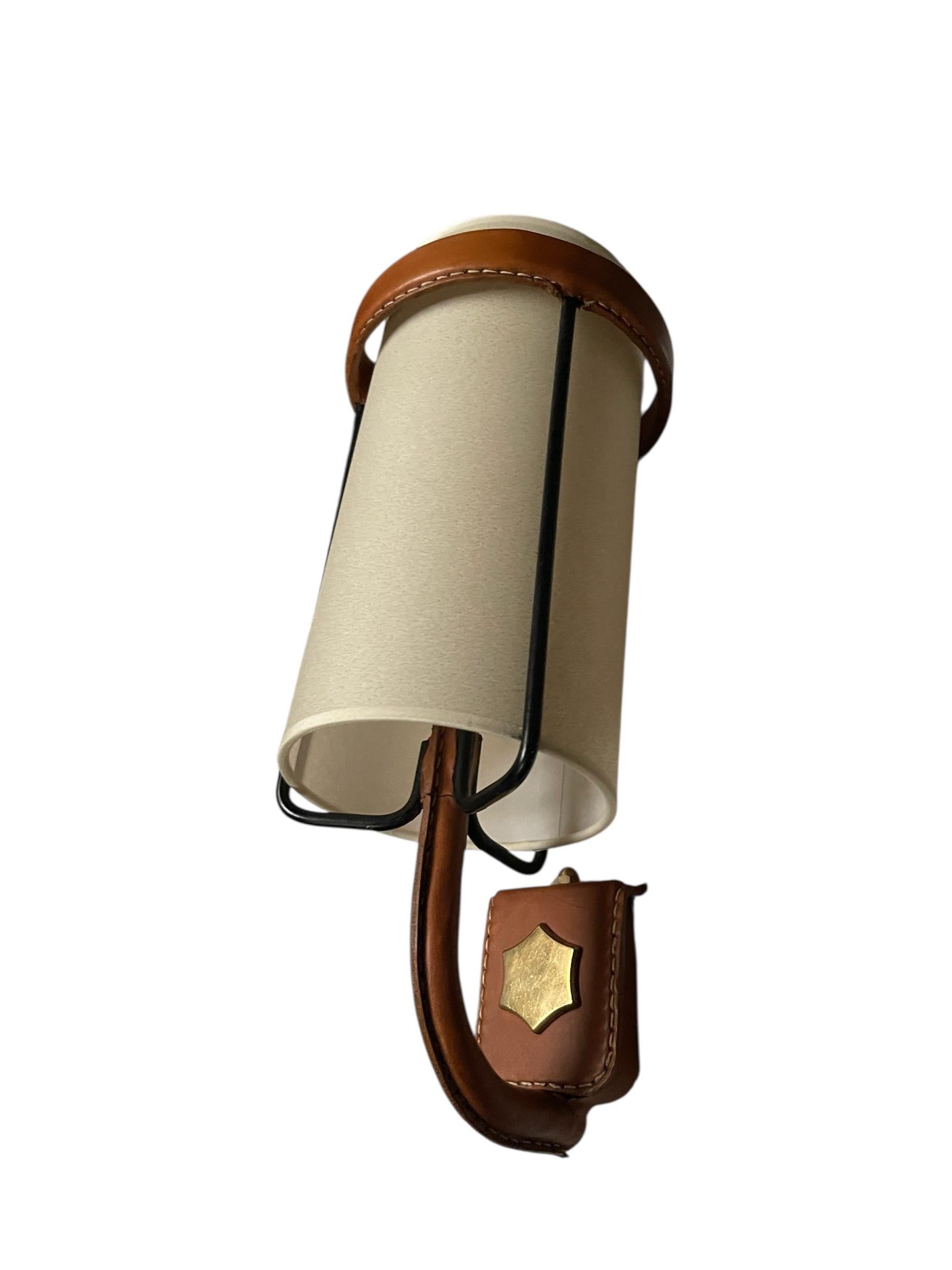 1950's Stitched leather sconces by Jacques Adnet Metal en venta