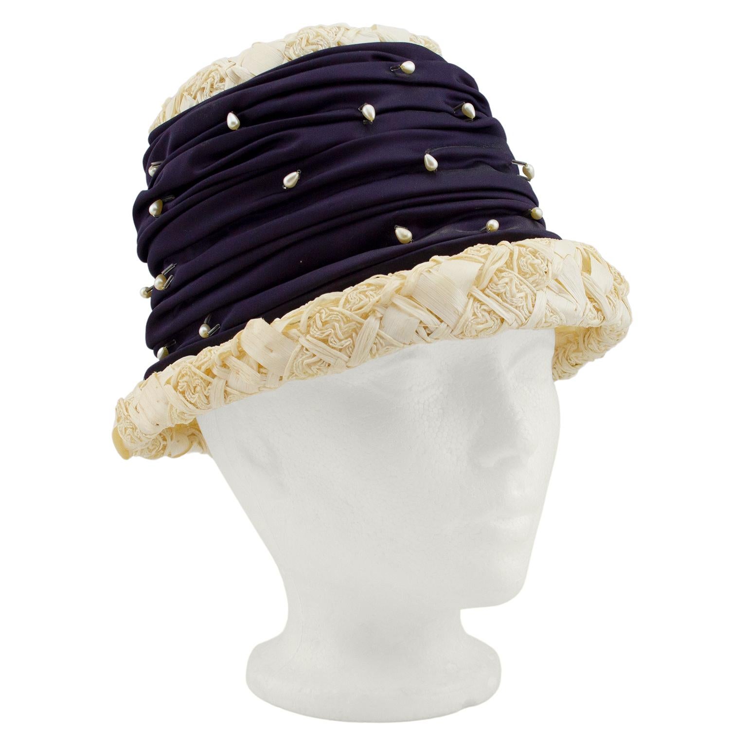 Darling hat from the 1950s. Natural straw with thick large ruched satin band around the crown of the hat, embellished with small teardrop shaped pearls and beads. Small brim. Excellent vintage condition. Average size.