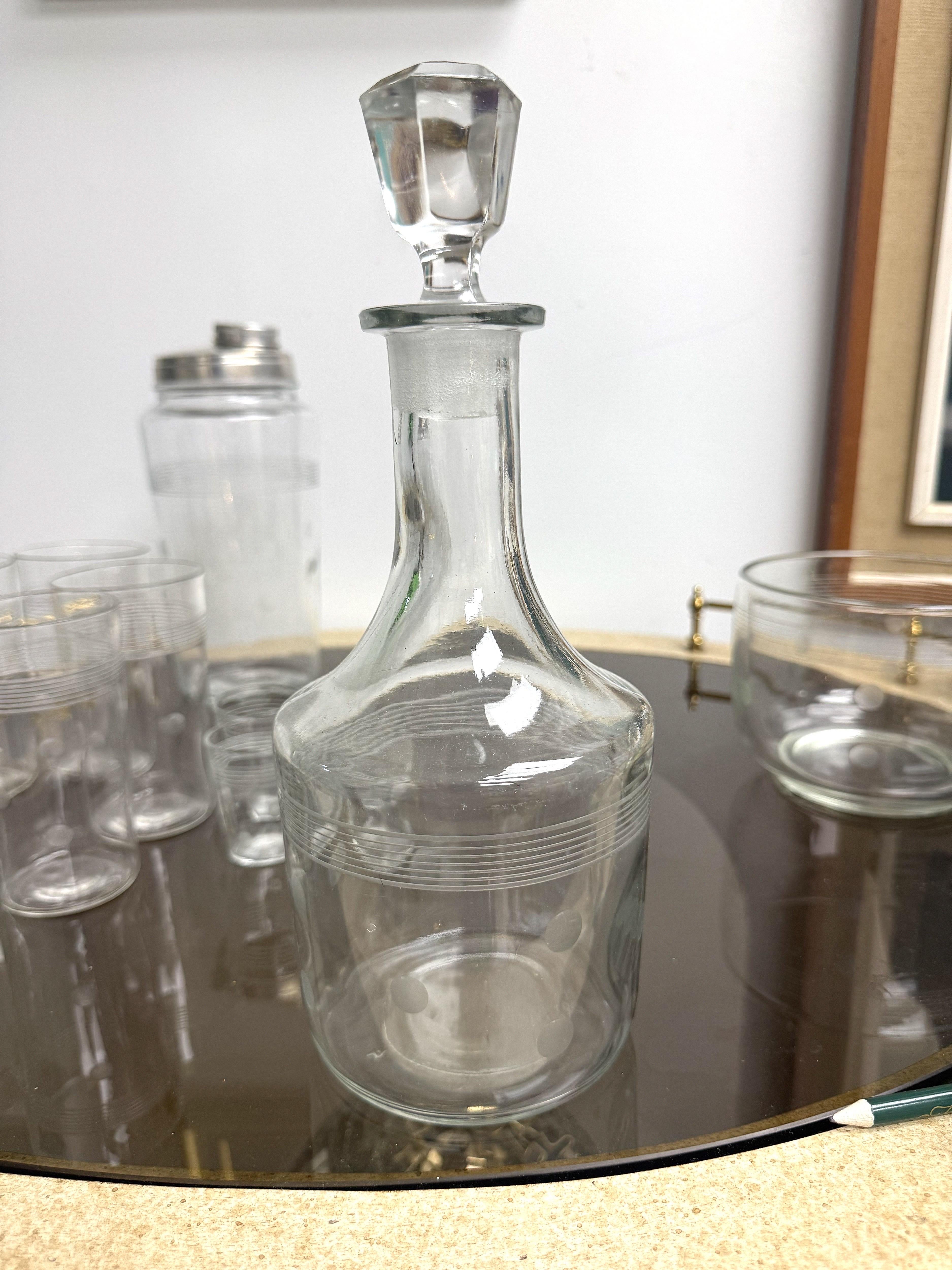 This fantastic 1950’s bar ware set includes 1 decanter, one ice bucket/champagne chiller, 1 cocktail shaker, 5 cocktail glasses and 4 shot glasses.  This is a rare and absolutely stunning set.   Very classy and yet playful.  


The decanter