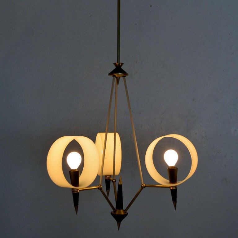 1950s modern three arm Italian chandelier sculptural opaline glass style of Stilnovo Italy
Unmarked.
Opaline circle diffusers with aluminum cones painted in black and polished brass.
Spectacular design exposed E-14 bulbs-they are not